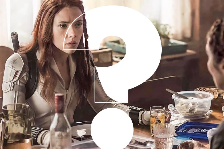 She sits at a dinner table in a white catsuit with some sort of sword in a sling on her back. She looks confused. In front of her is photoshopped a giant question mark.