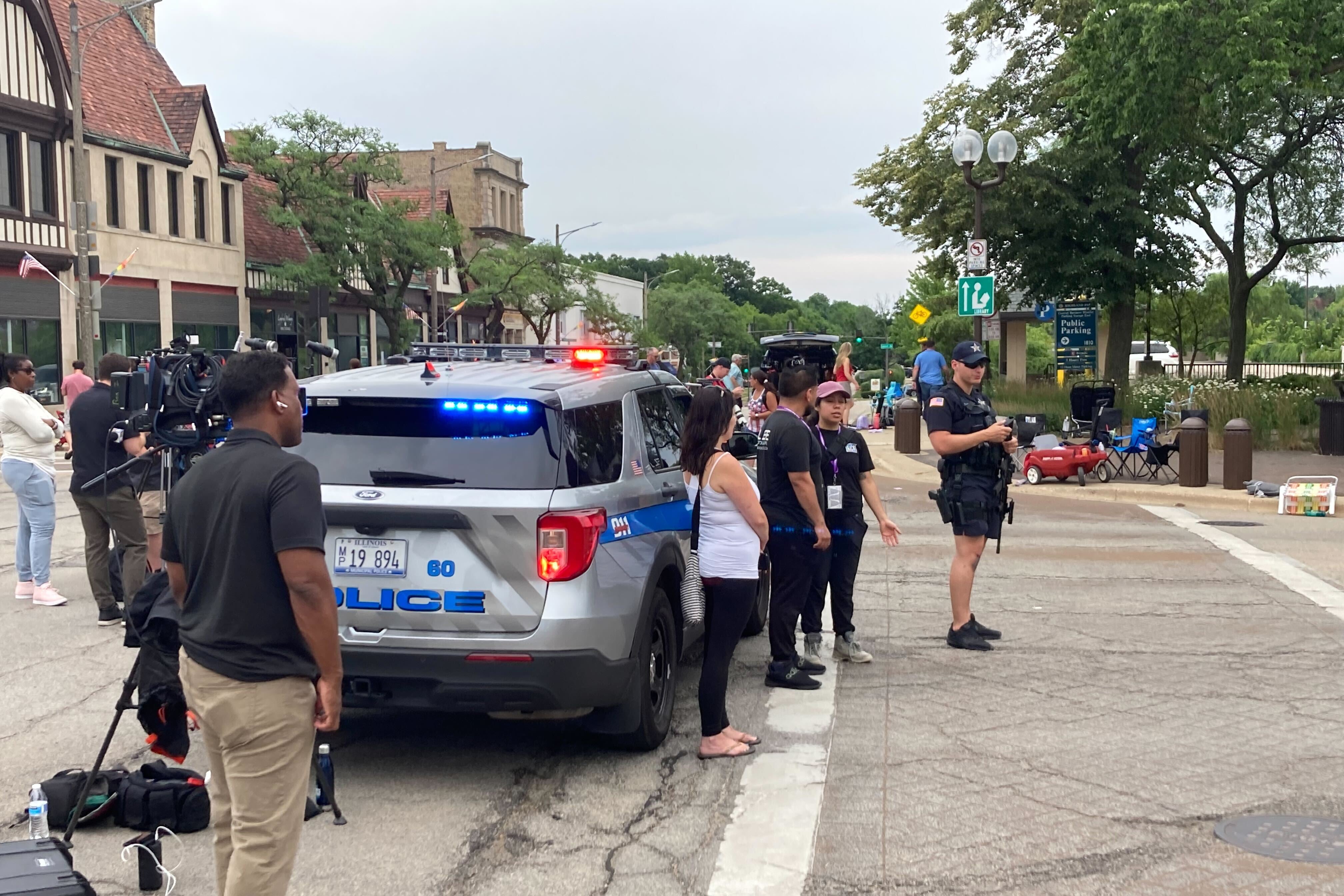 Police, media, and onlookers look west on Central Ave. toward the crime scene.