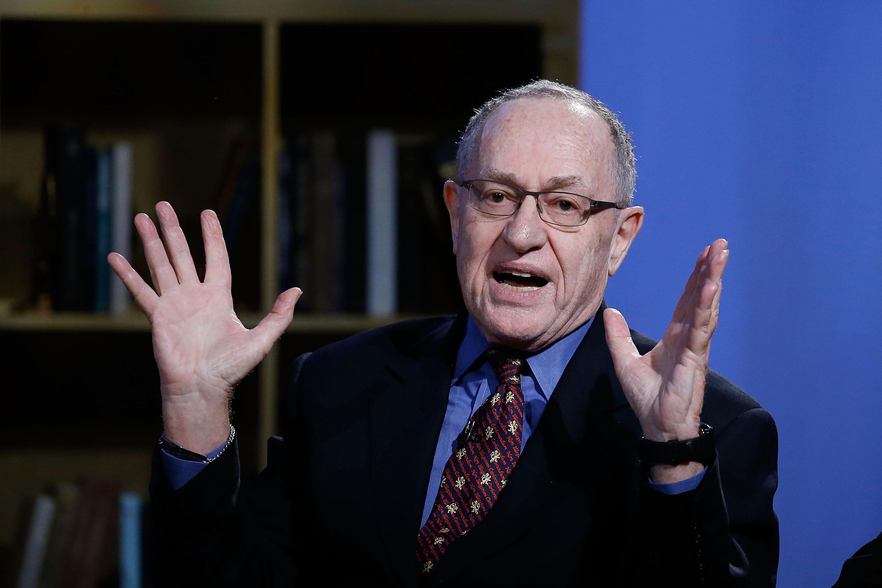 Alan Dershowitz gestures while sitting for an interview.