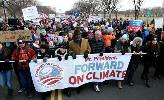 Texas Gulf Coast activist Hilton Kelley (hat, middle) and Bill McKibben lead an estimated 40,000 marchers for the Forward on Climate rally on Feb 17, 2013.
