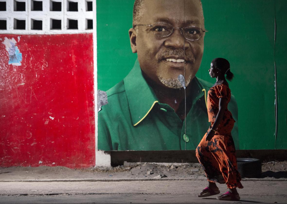 A woman walks past an election billboard after ruling party Chama Cha Mapinduzi candidate John Magufuli was named Tanzania's president-elect on Oct. 29, 2015. 