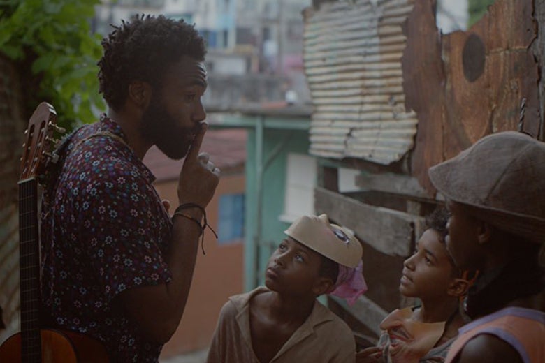 Donald Glover shushes some children in a still from Guava Island.