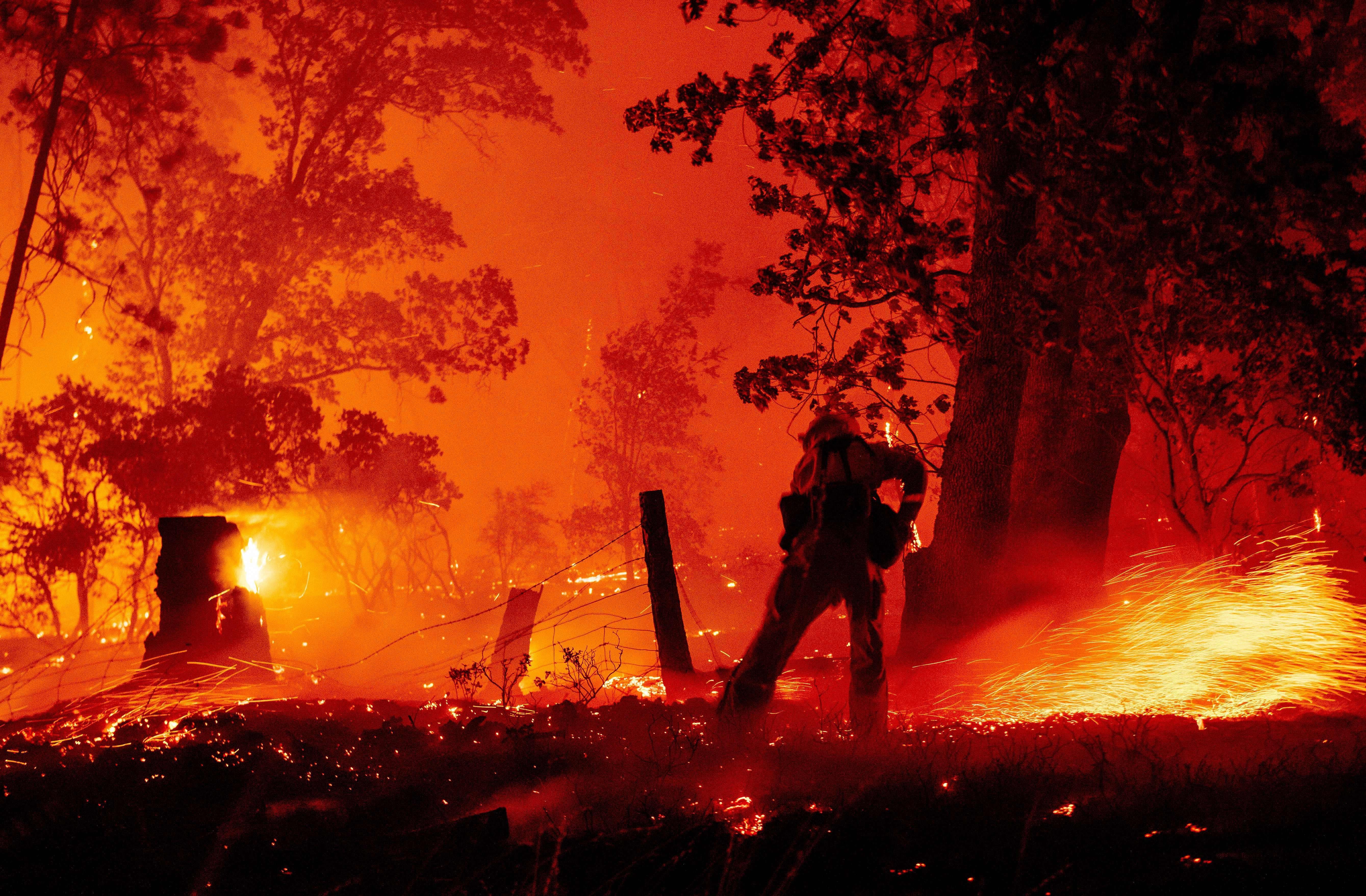 A firefighter works the line as flames push towards homes during the Creek fire in the Cascadel Woods area of unincorporated Madera County, California on September 7, 2020. 