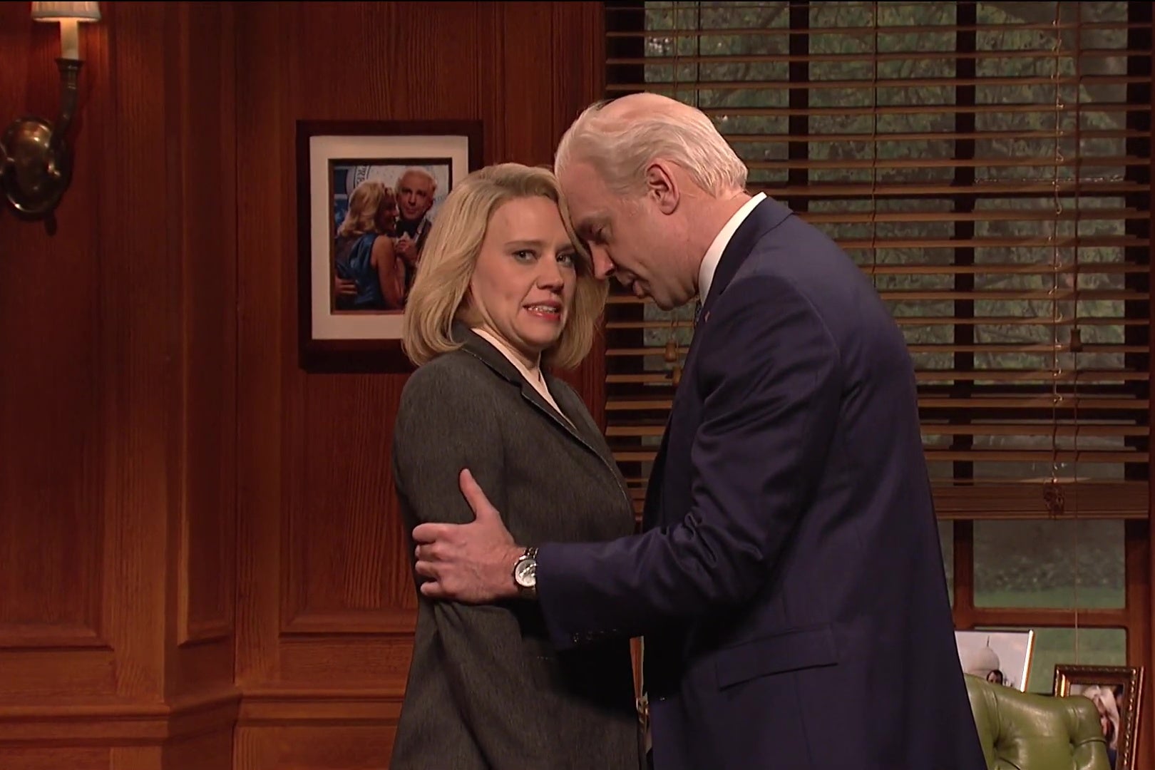 Kate McKinnon grimaces as Jason Sudeikis, as Joe Biden, holds her shoulders and rubs his nose against hers in this still from Saturday Night Live.