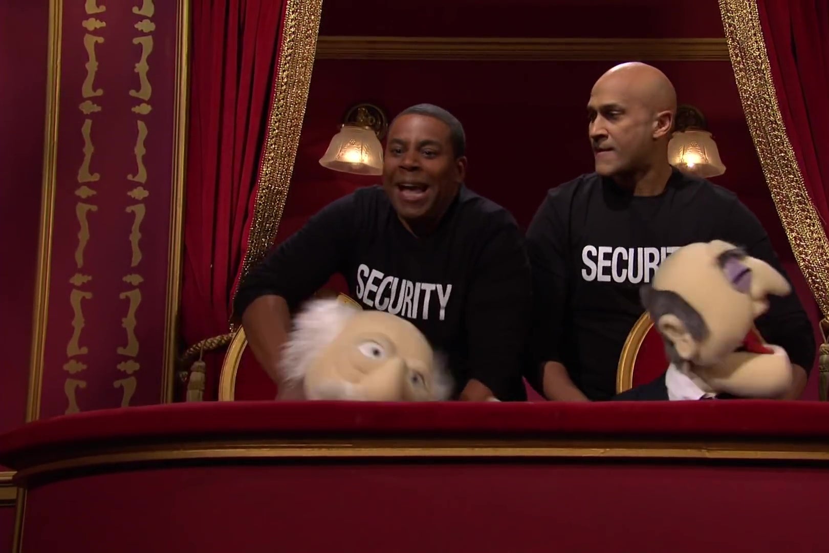 Kenan Thompson and Keegan Michael Key, wearing shirts reading SECURITY, stand behind Statler and Waldorf puppets, strangling them.