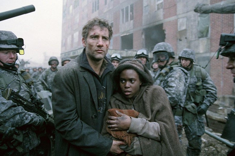 A battered Clive Owen ushers a hooded Black woman carrying a baby through a crowd of militia. 