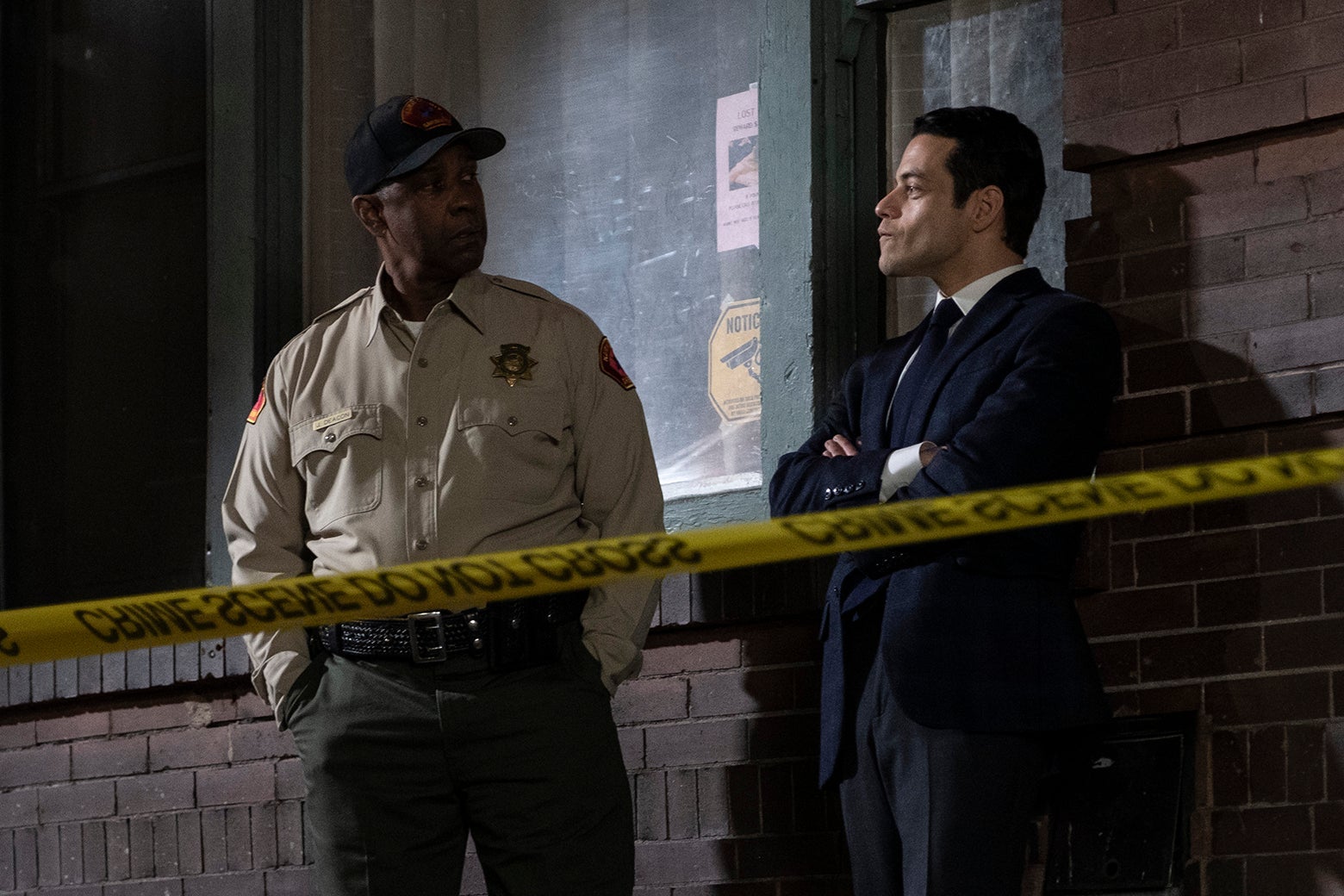 Denzel Washington in a Sheriff's department uniform as Joe “Deke” Deacon and Rami Malek, in a suit, as Jim Baxter, in “The Little Things.”
