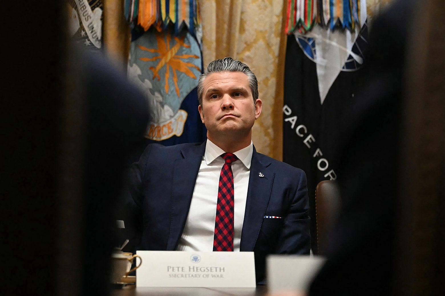 Hegseth glowering.