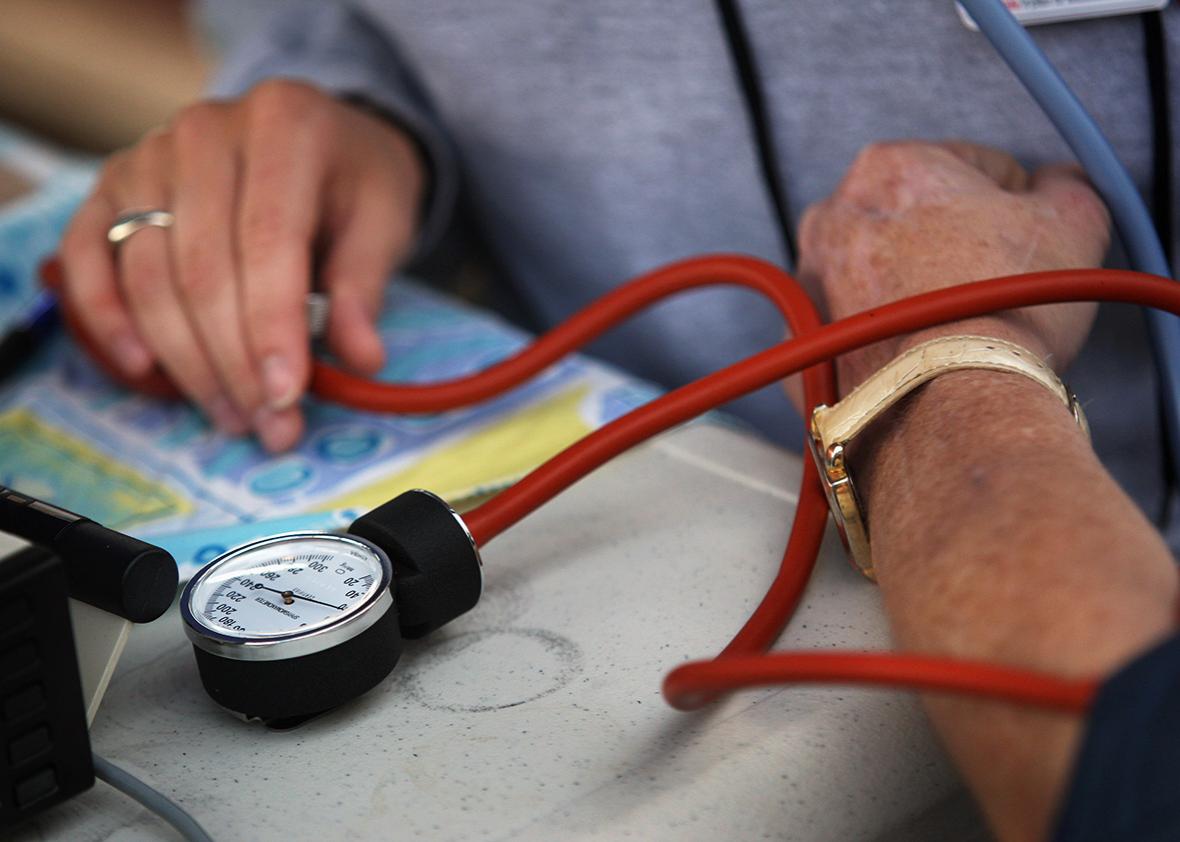 A nurse checks a patient’s blood pressure at the Remote Area Medical health care clinic in Wise, Virginia.