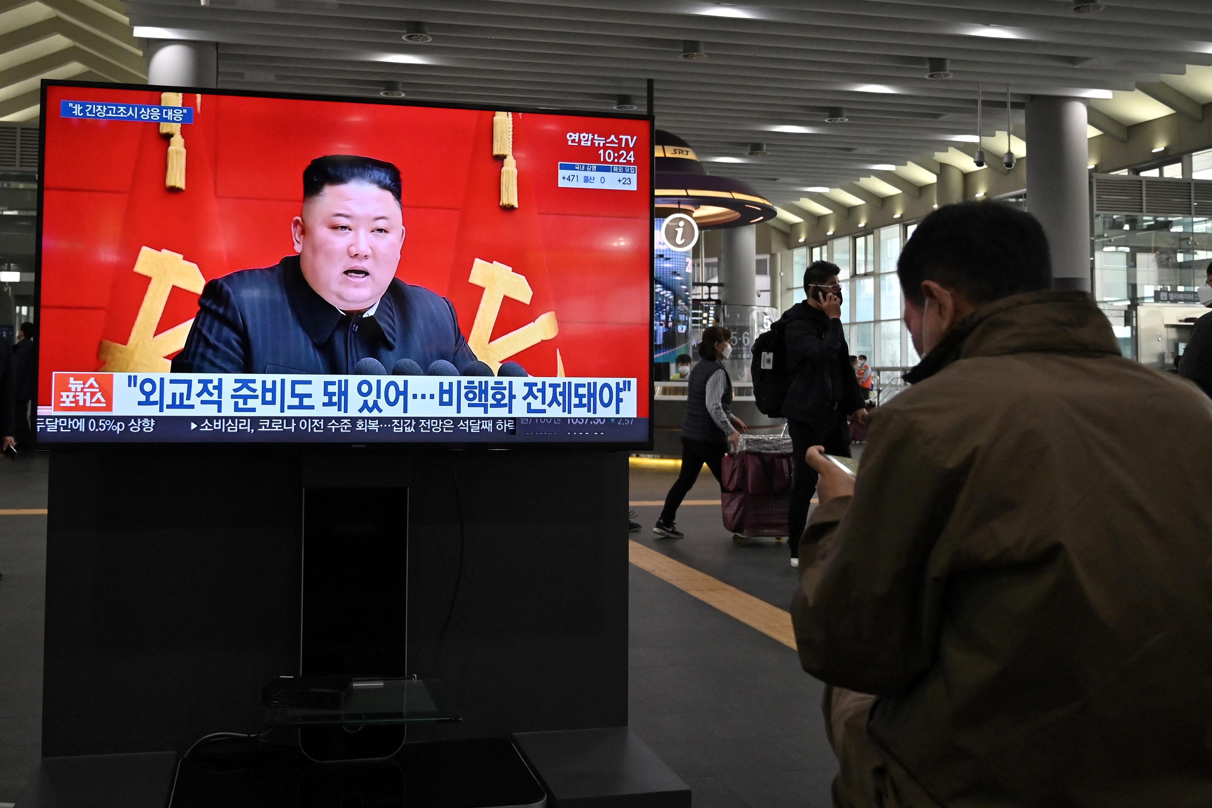 People watch a television screen at Suseo railway station in Seoul on March 26, 2021, showing file footage of North Korea's leader Kim Jong Un.