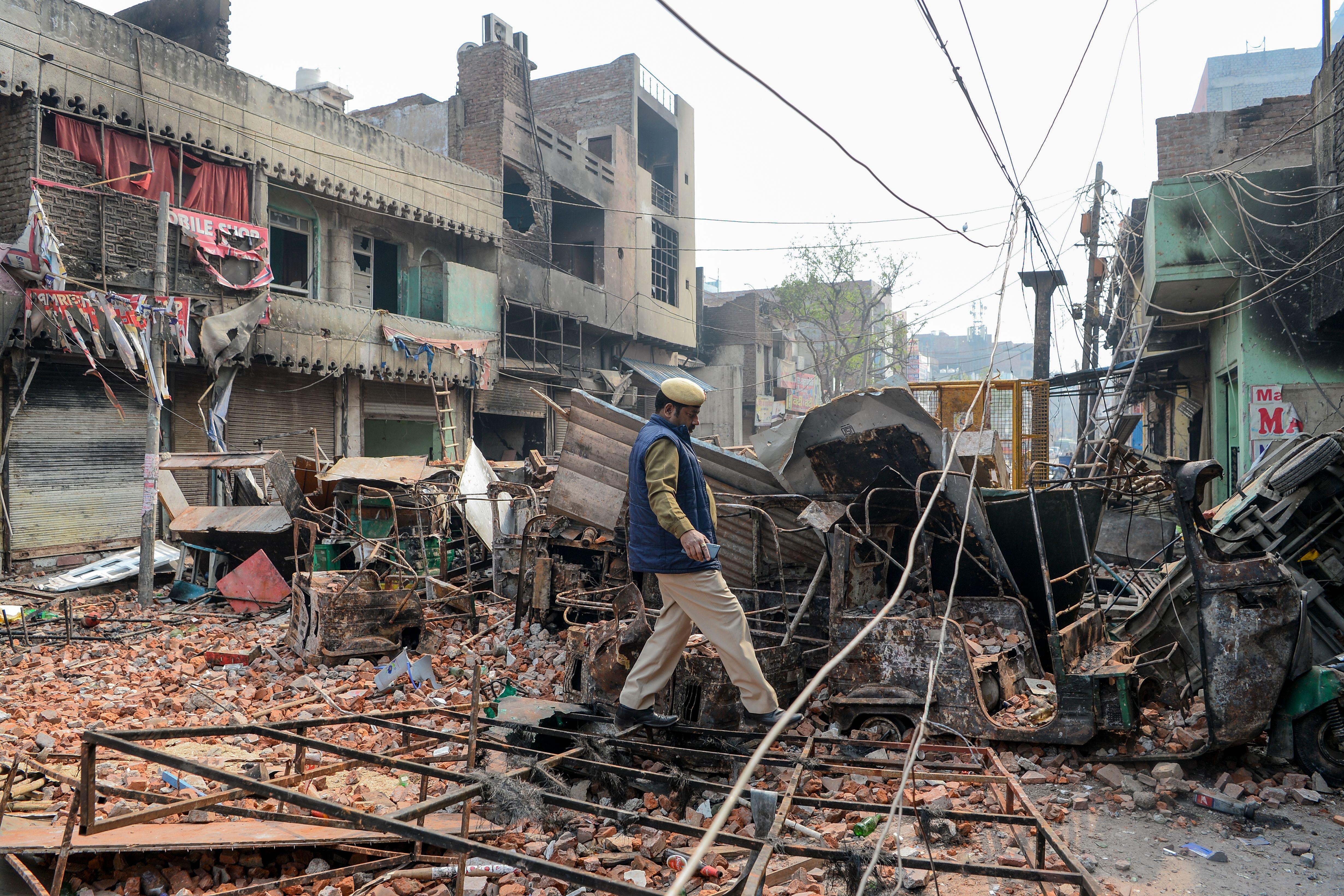 A man walks amid rubble.