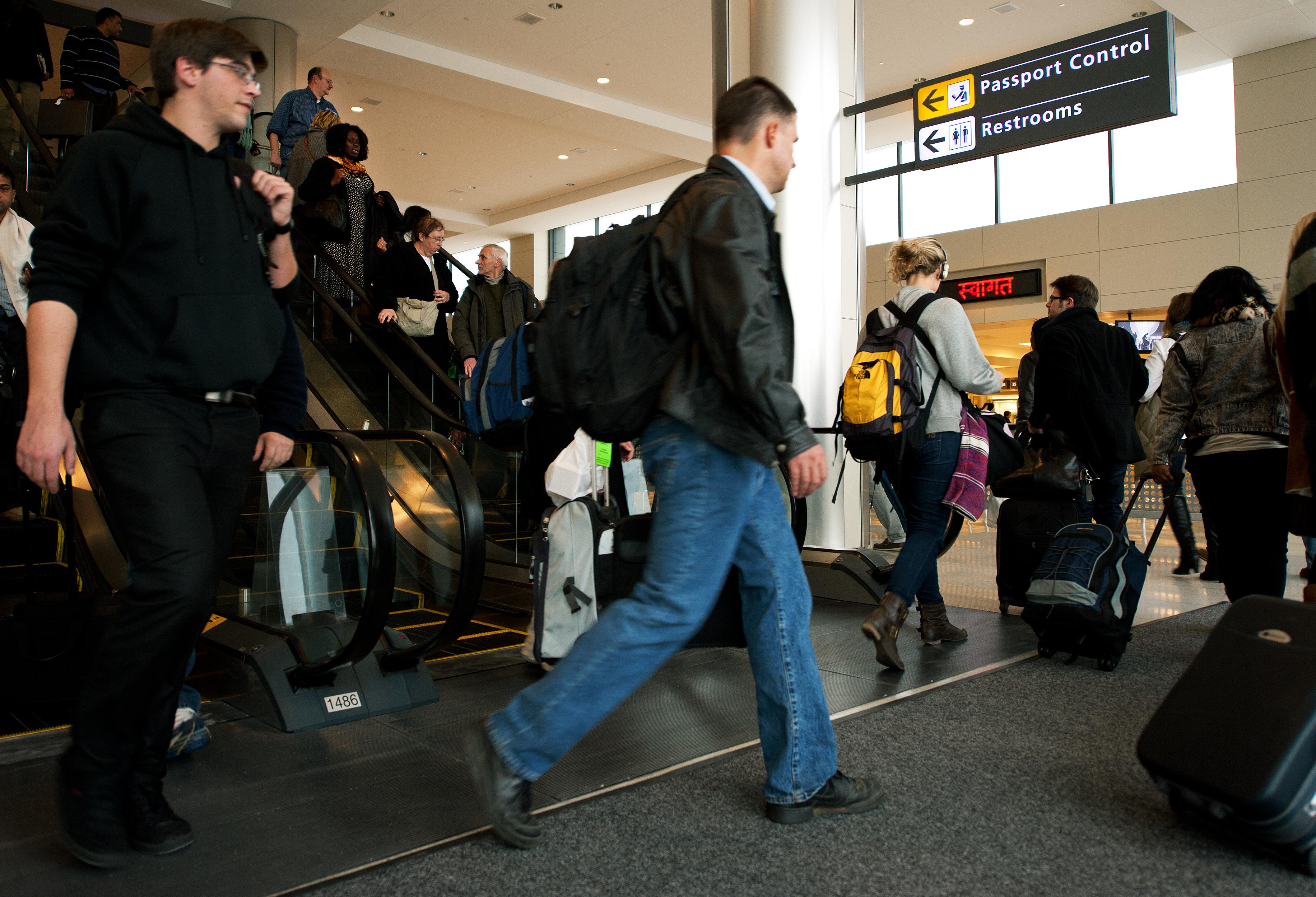 International air travelers entering the United States head to 'Passport Control' inside the US Customs and Immigration area.