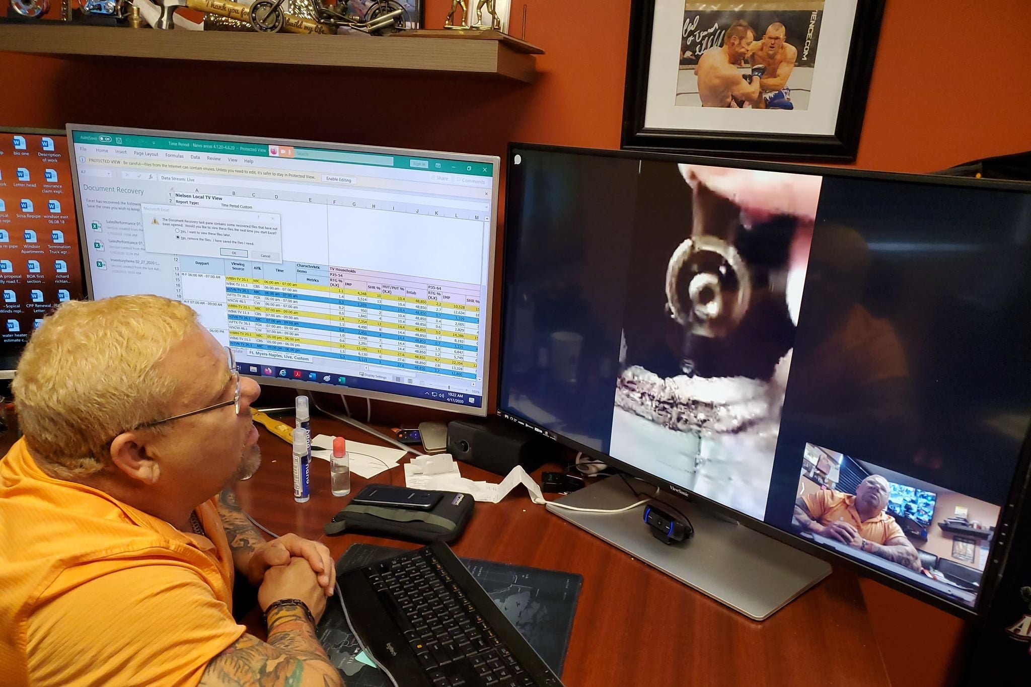 A man sits in front of a desktop computer monitor, and in a Zoom window on screen, some pipes can be seen.