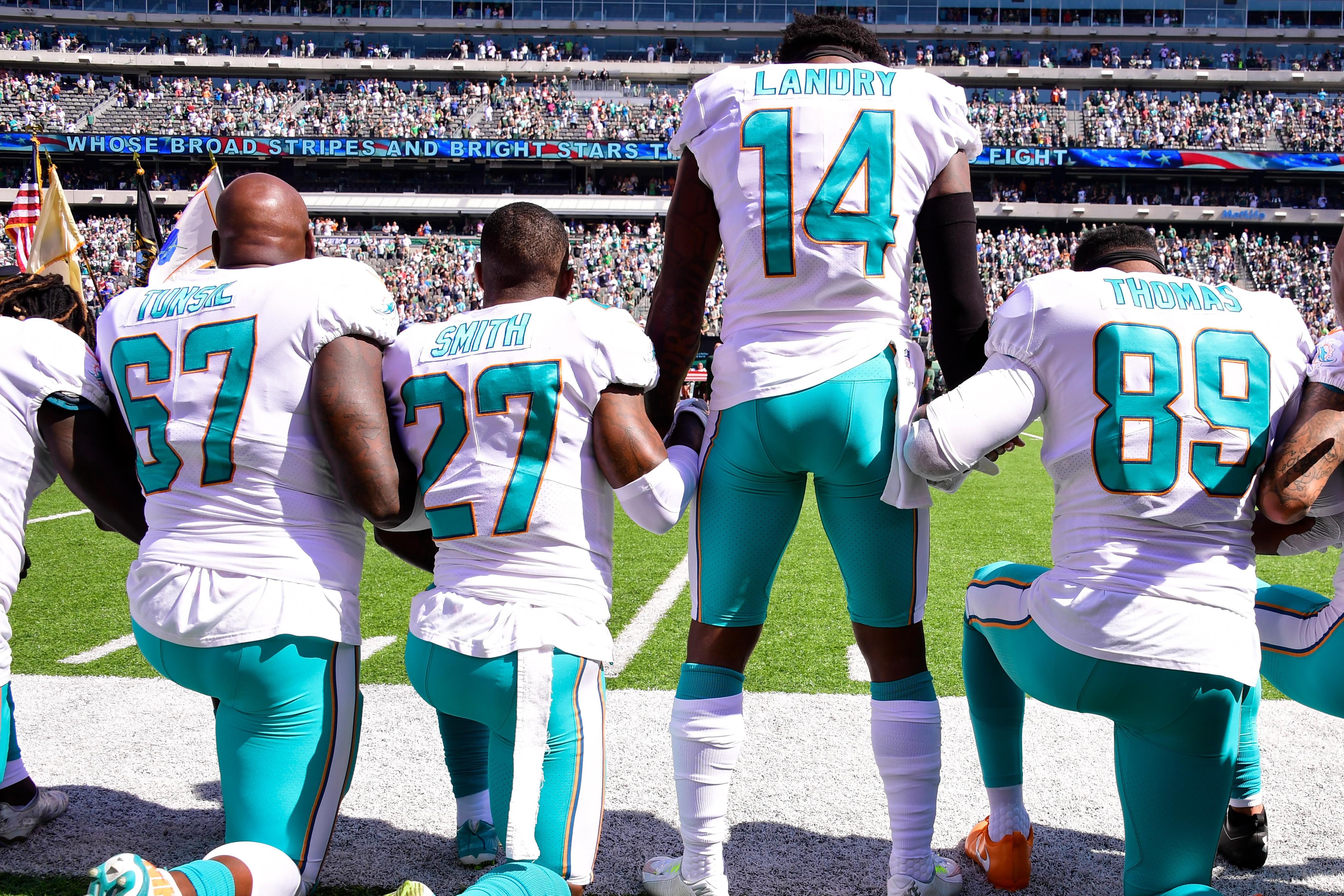 Fans burn Dolphins jerseys to protest anthem kneeling