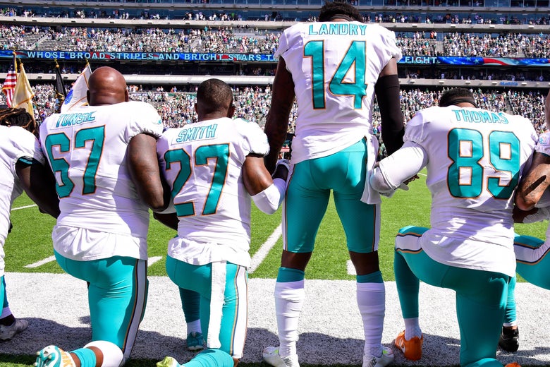 Miami Dolphins players kneel on-field during the National Anthem before playing the New York Jets at MetLife Stadium on Sept. 24, 2017.