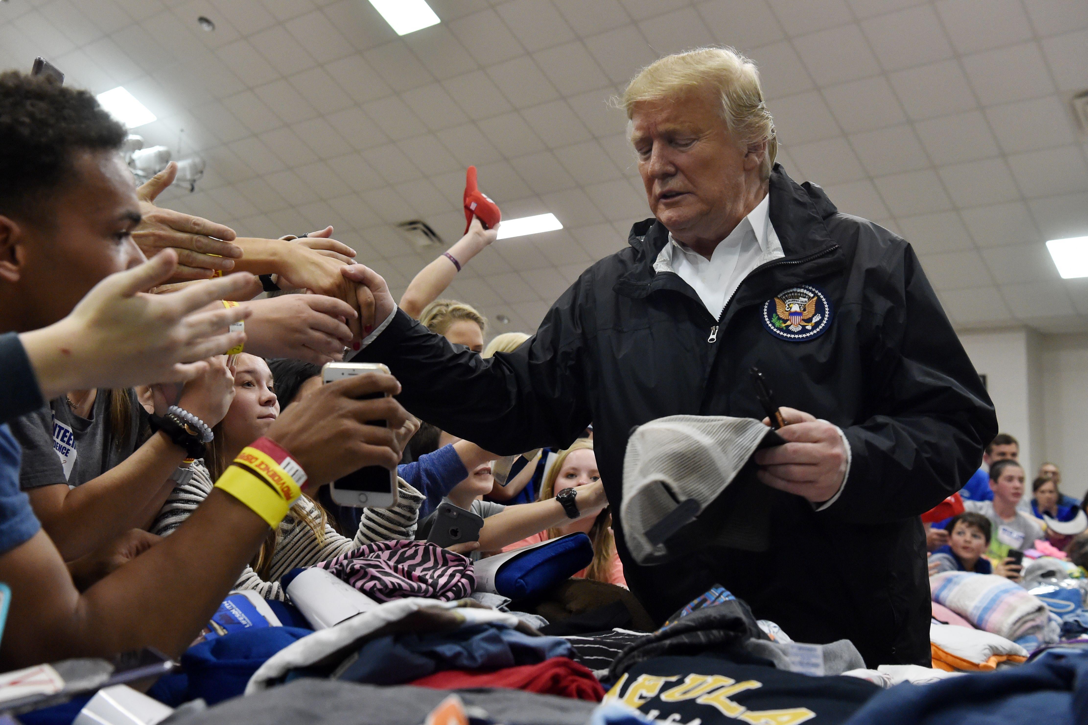 President Donald Trump greets residents.