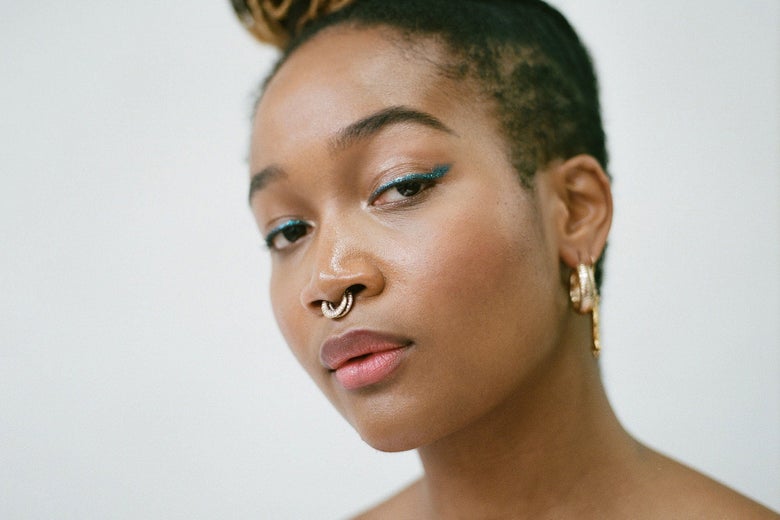 A young black woman with a confident look.