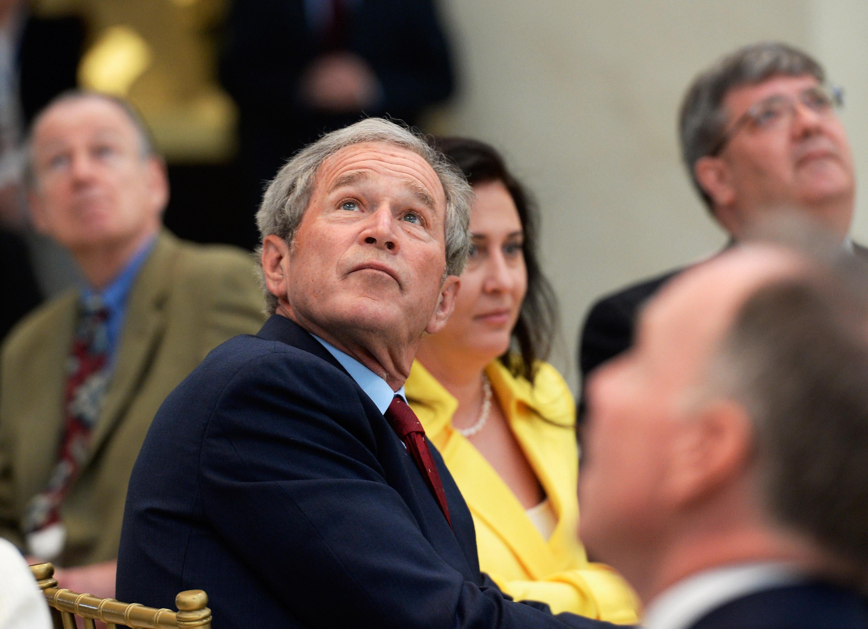 Former President George W. Bush looks at the 360-degree LED high-definition video wall inside the Freedom Hall in Dallas as he participates in a signing ceremony for the joint use agreement between the National Archive and the George W. Bush Presidential Center.