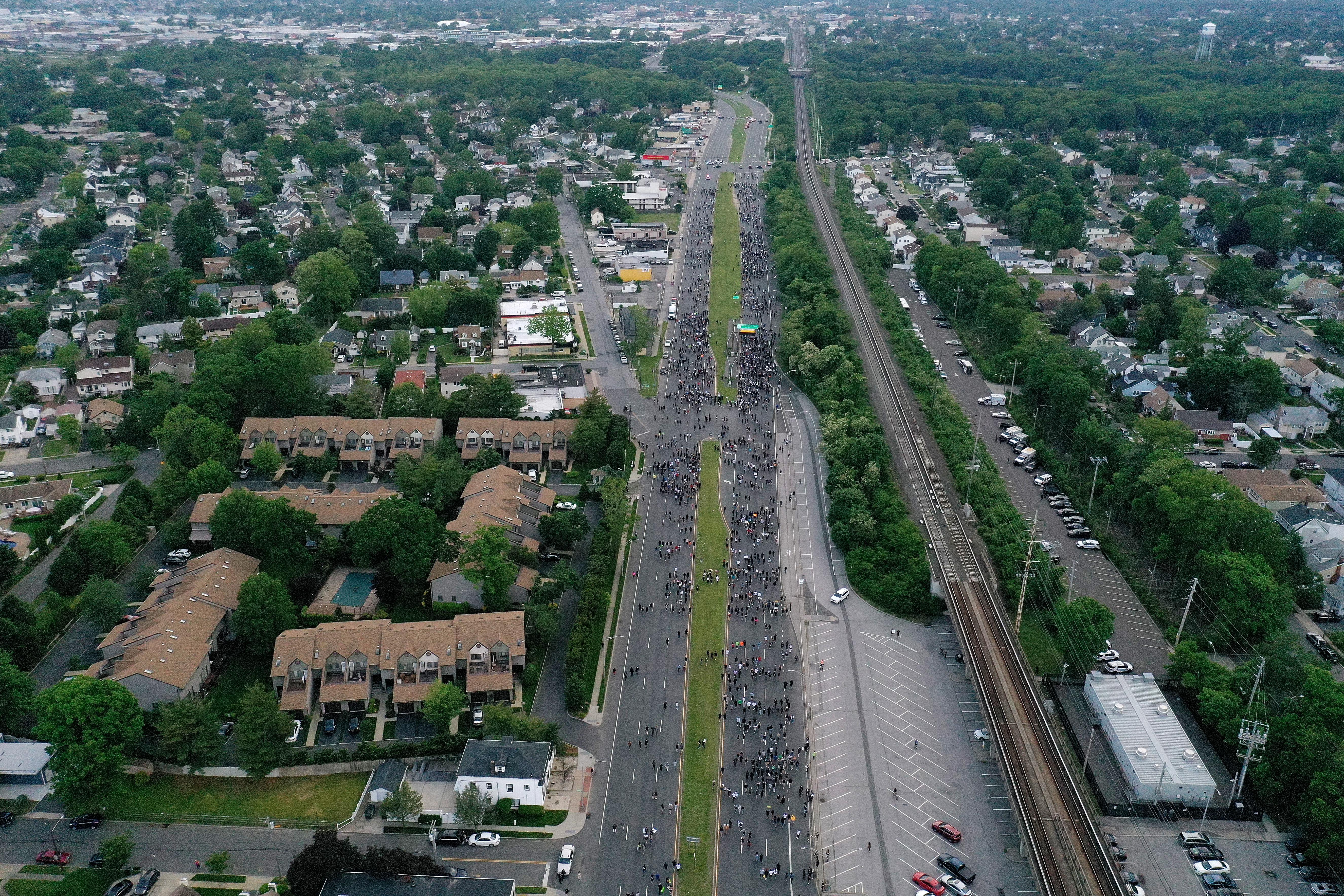 An aerial view of protesters marching down a large highway in Merrick, New York.