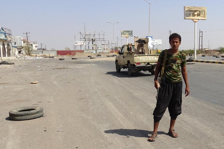 A member of Yemeni pro-government forces stands in a street on the eastern outskirts of Hodeida as they continue to battle for the control of the city from Huthi rebels on November 13, 2018.
