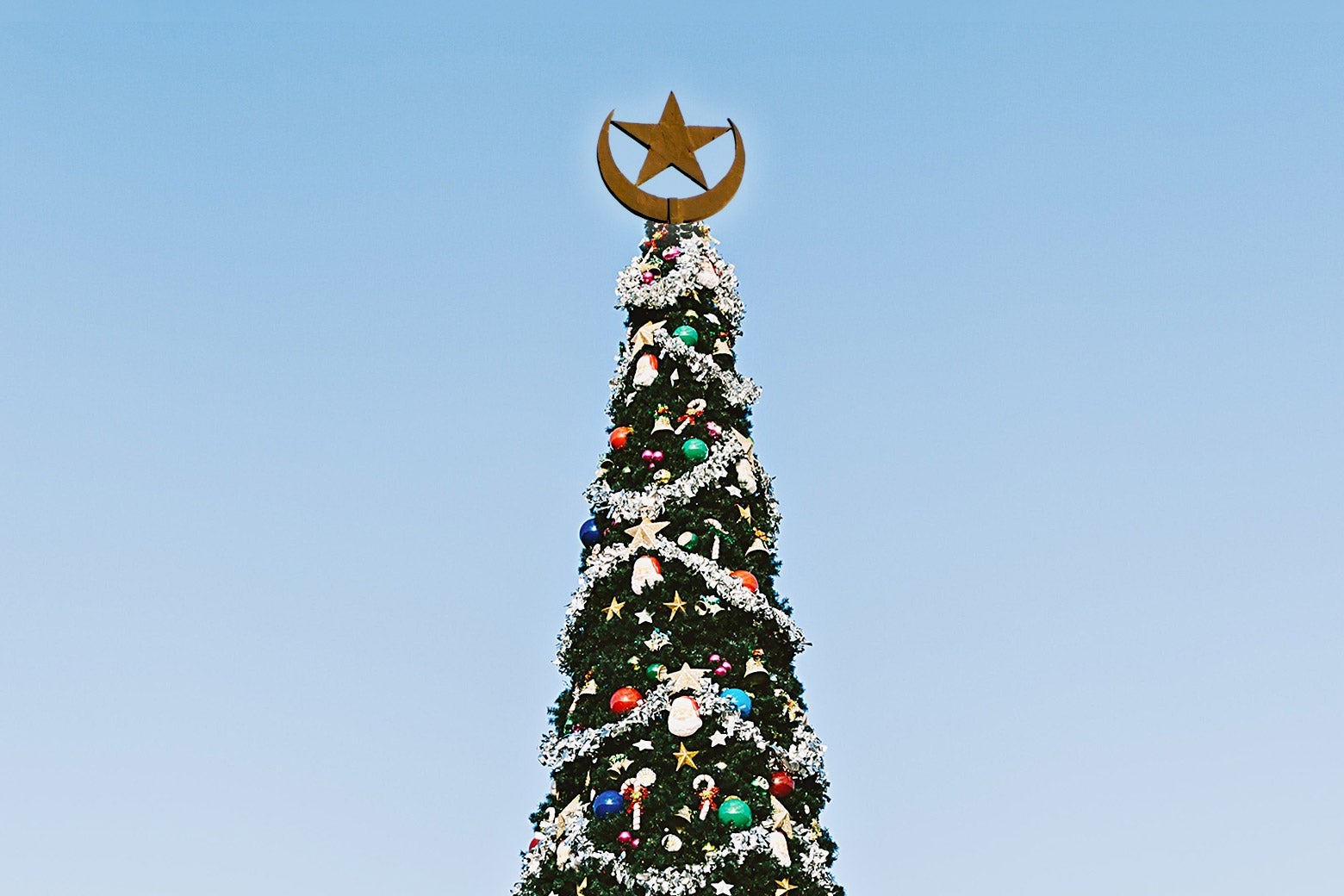 A Christmas tree with an Islamic star and crescent on top.