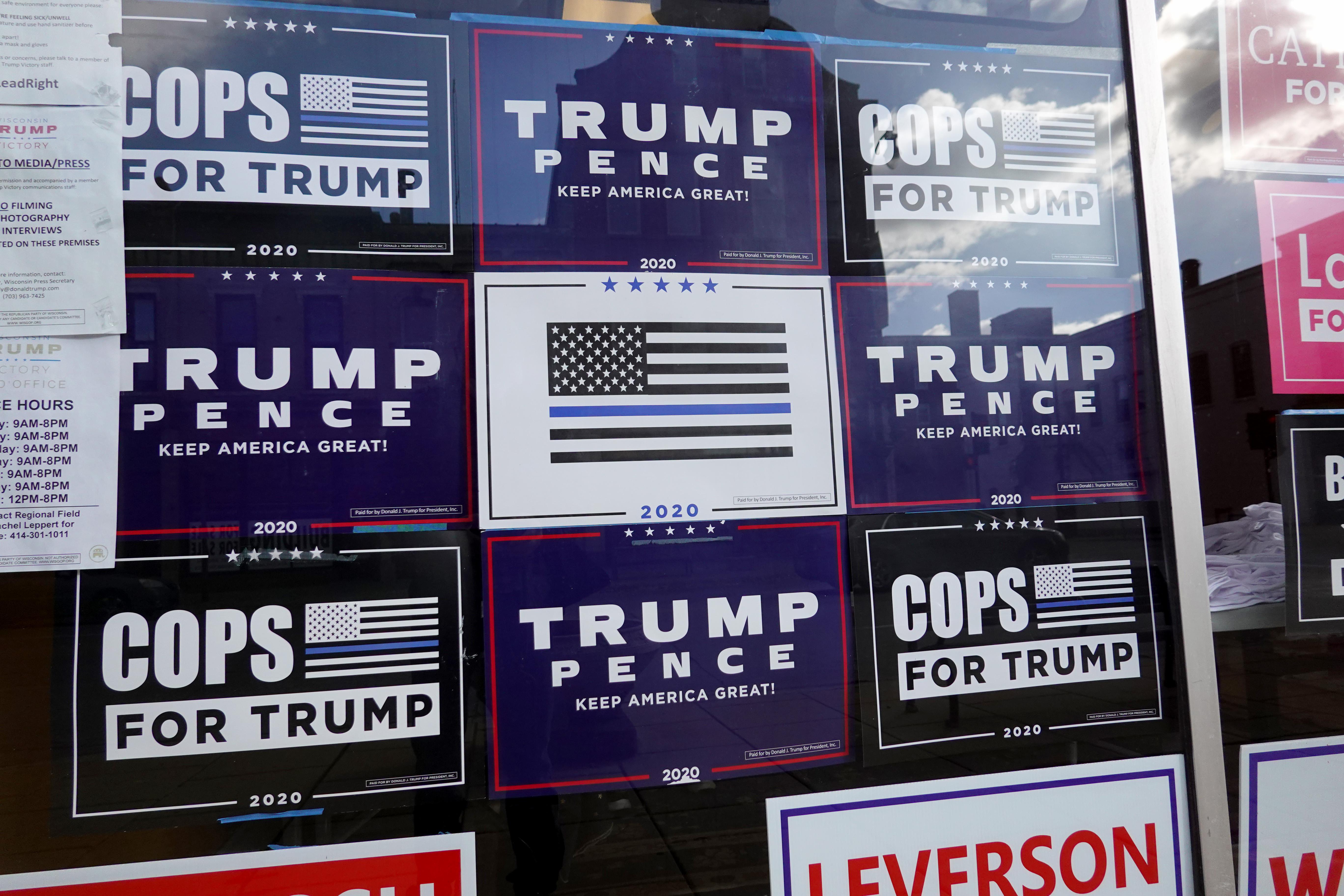 Trump campaign signs are seen affixed on a window.