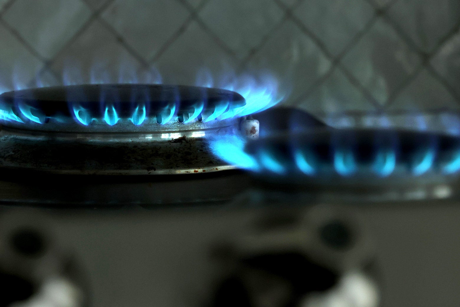 Two lit gas stove burners.