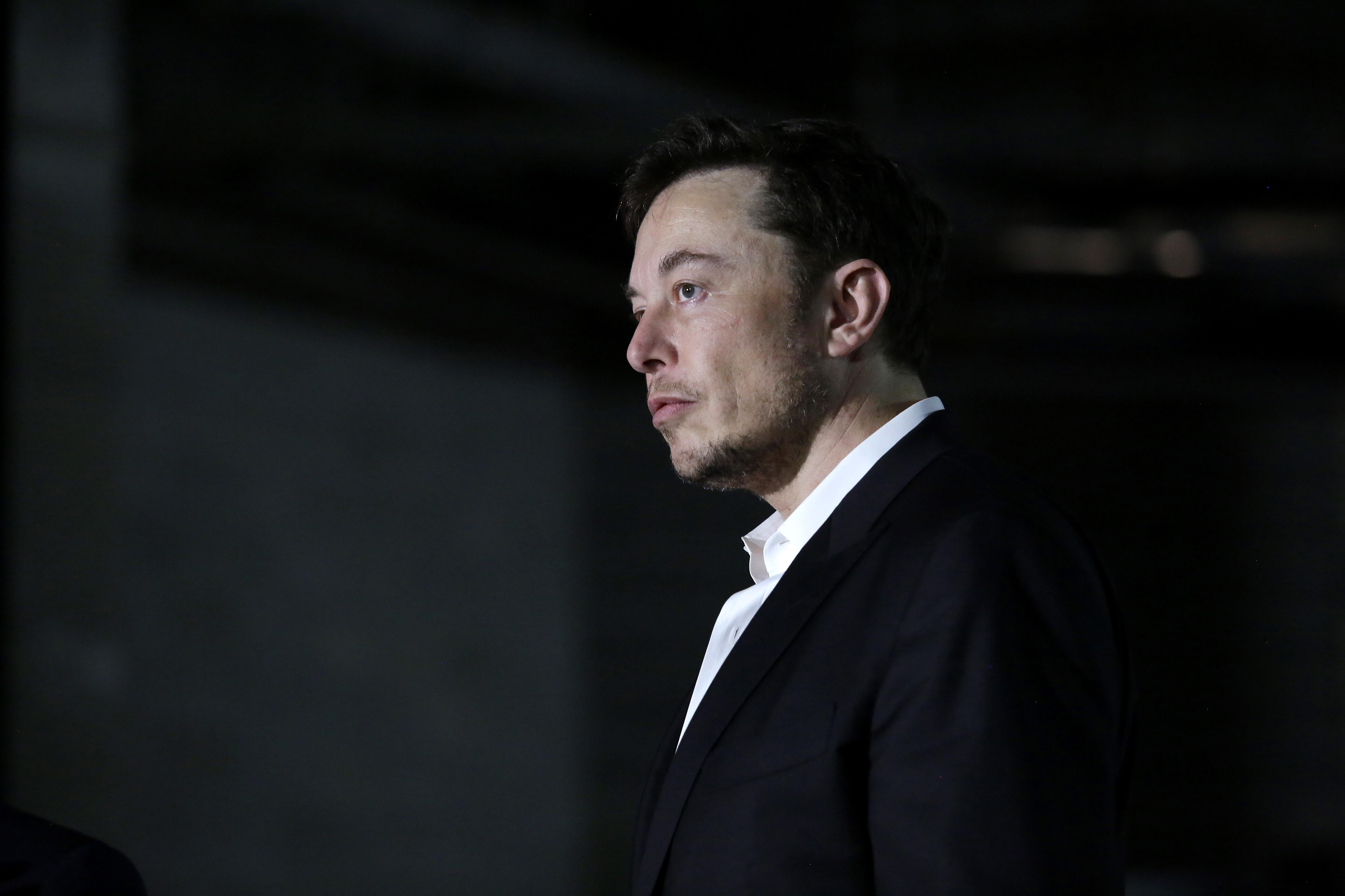 Elon Musk stands at a news conference on June 14 in Chicago. Maybe he is sleepy.