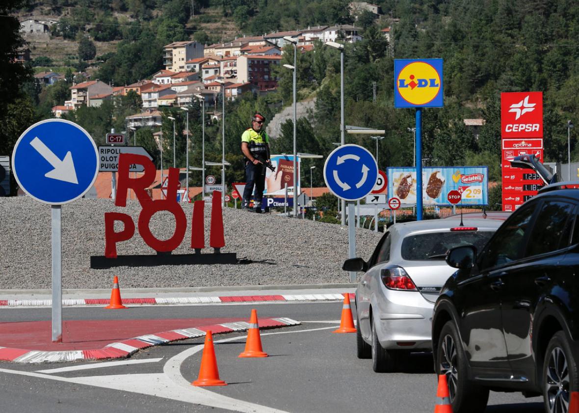 A Police officer stands guard at a road control in Ripoll on August 20, 2017, as part of an operation to find a suspect of Barcelona's attack.