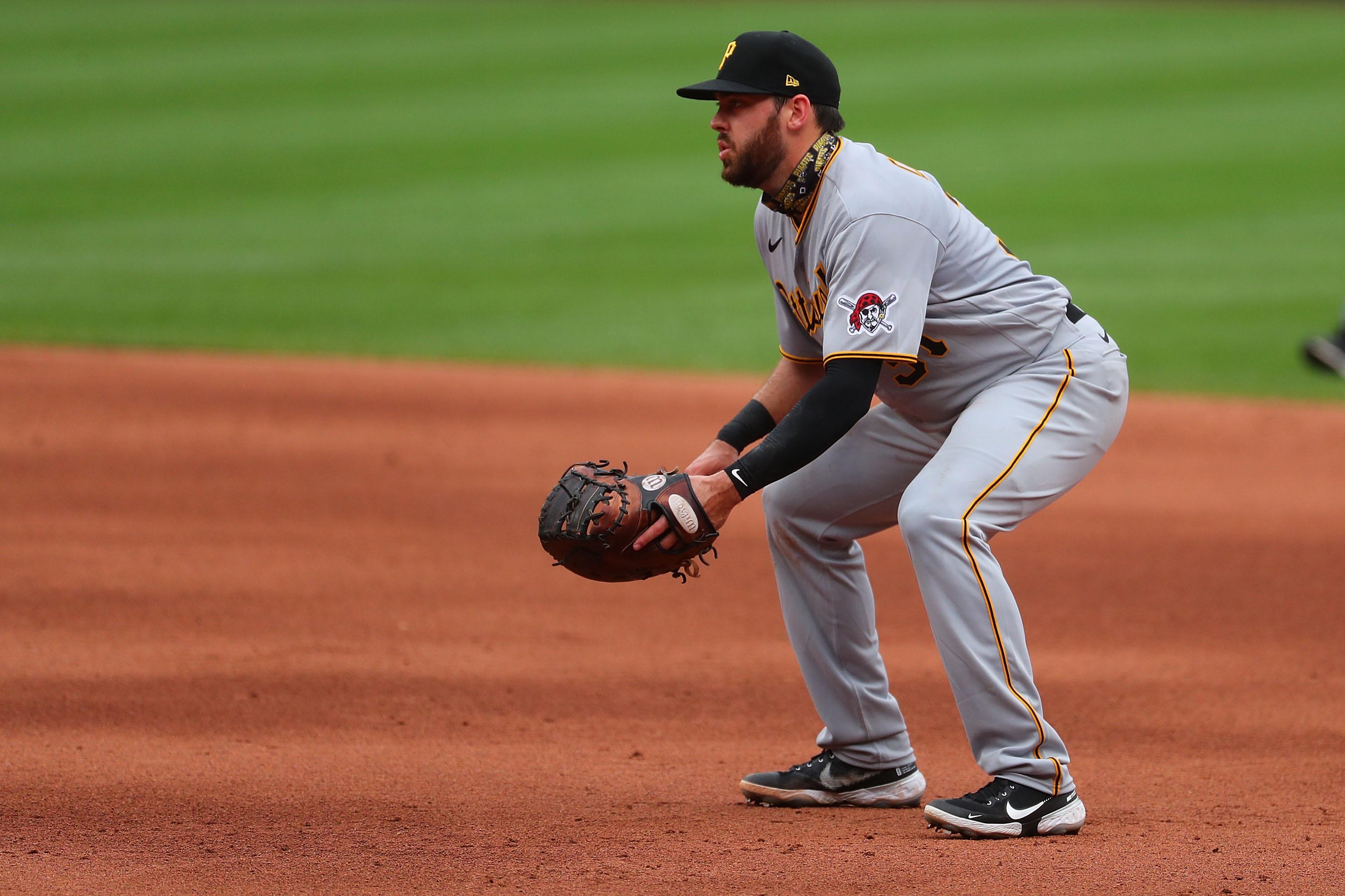 A player in a Pirates uniform plays first base.