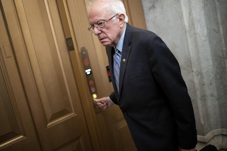 Sanders pushes a button to call an elevator