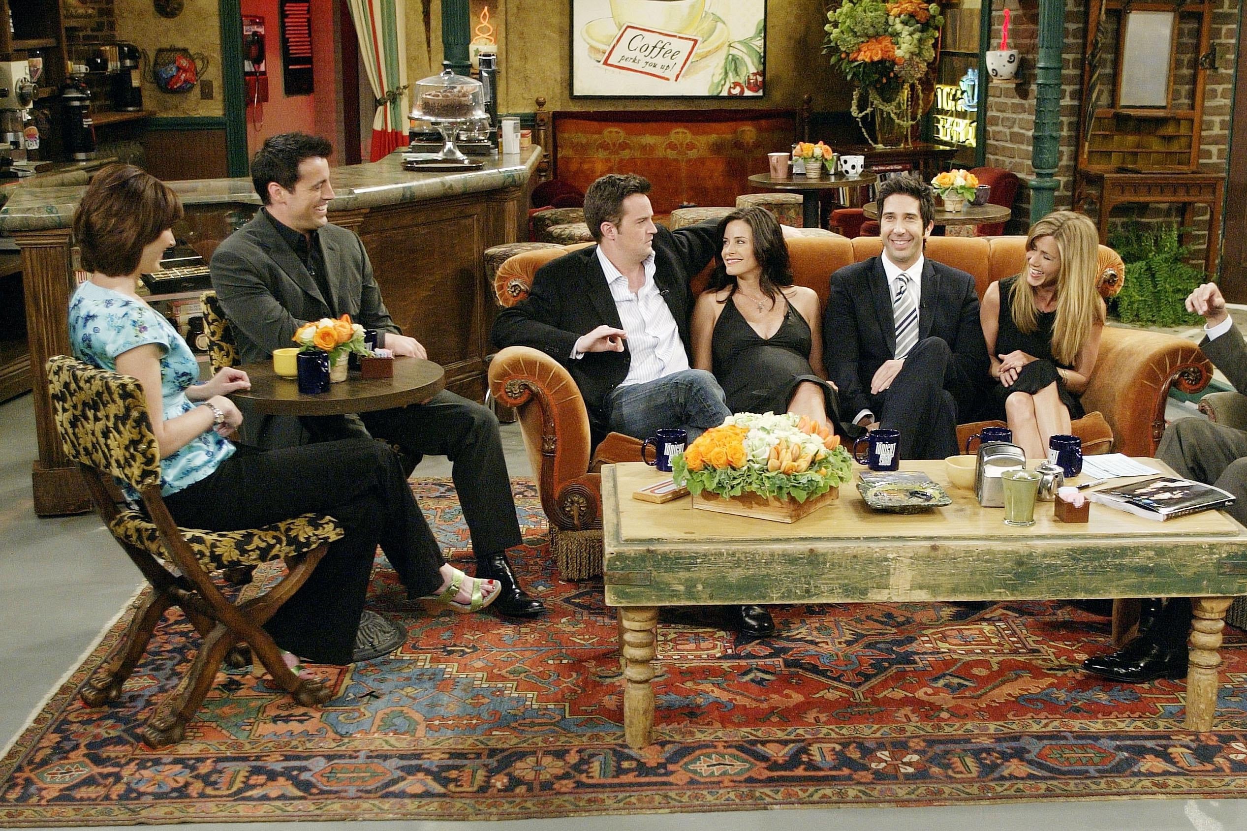 In this handout photo provided by NBC, the cast of "Friends", actors Lisa Kudrow, Matt LeBlanc, Matthew Perry, Courteney Cox-Arquette, David Schwimmer and Jennifer Aniston sat down with Jay Leno for a special "Tonight Show," on the set of Central Perk on May 6, 2004 in Los Angeles, California. (Photo by Paul Drinkwater/NBC via Getty Images)