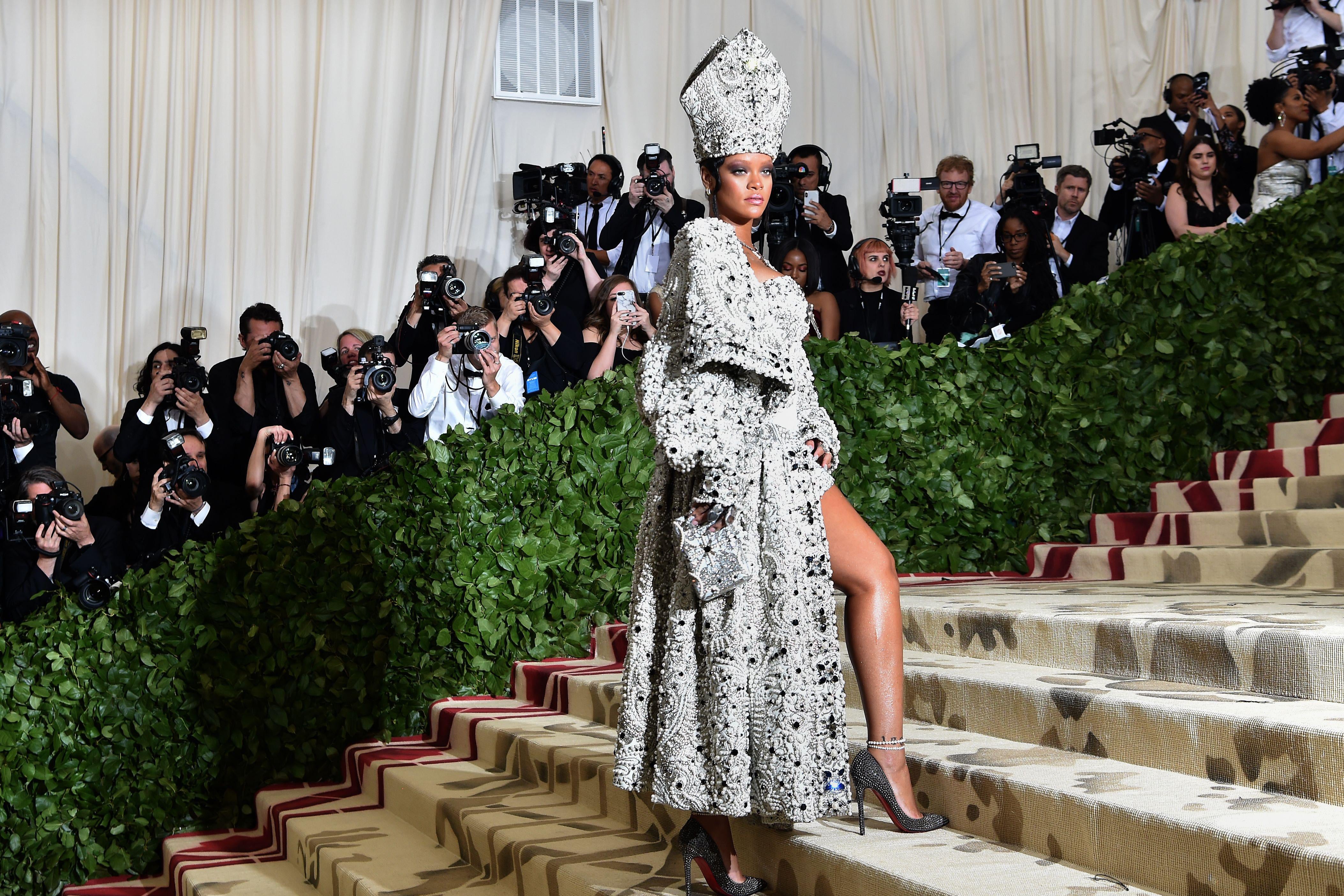 Rihanna arrives for the 2018 Met Gala on May 7, 2018, at the Metropolitan Museum of Art in New York. - The Gala raises money for the Metropolitan Museum of Arts Costume Institute. The Gala's 2018 theme is Heavenly Bodies: Fashion and the Catholic Imagination. (Photo by Hector RETAMAL / AFP)        (Photo credit should read HECTOR RETAMAL/AFP/Getty Images)