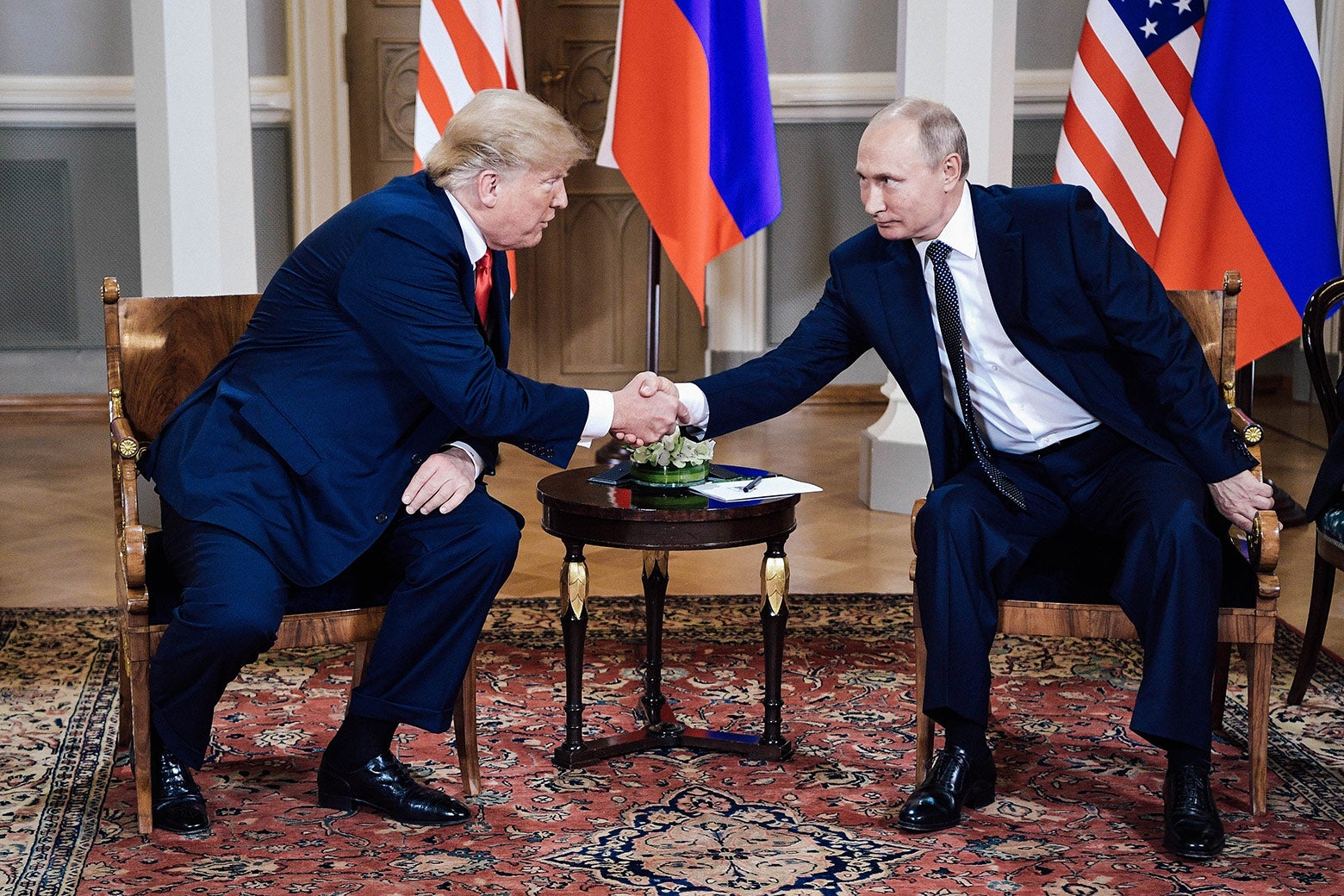 President Donald Trump shakes hands with Russia's President Vladimir Putin during a meeting in Helsinki, Finland, on Monday.