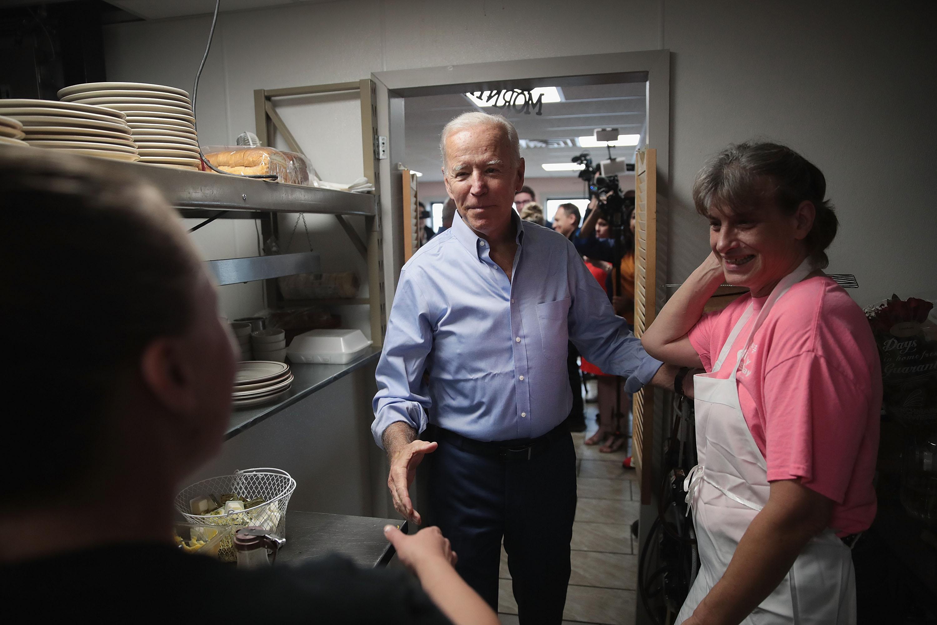 Democratic presidential candidate and former vice president Joe Biden greets the staff at the Tasty Cafe during a quick campaign stop at the restaurant on June 12, 2019 in Eldridge, Iowa.