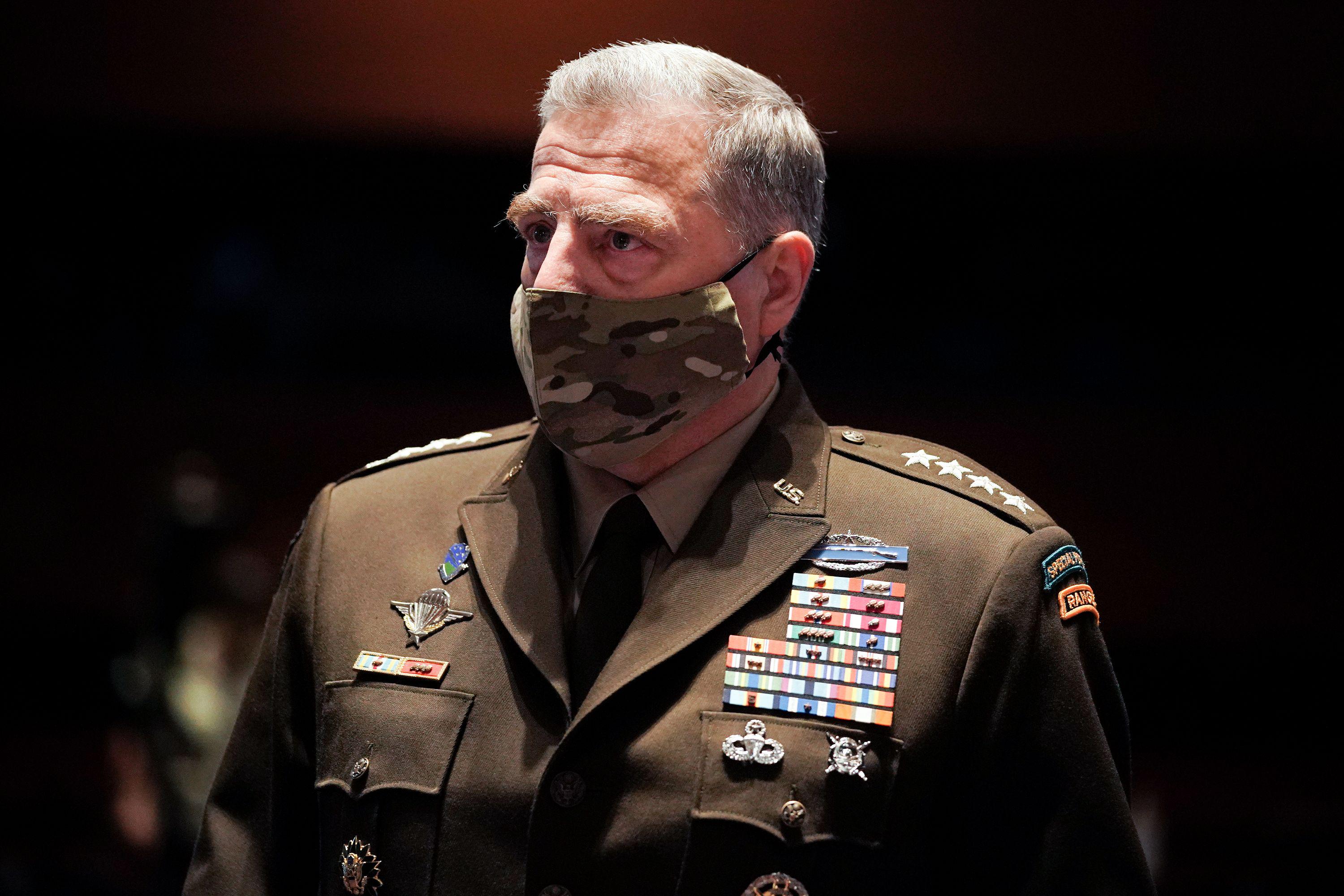 Milley wearing his uniform and a camo-patterned mask.