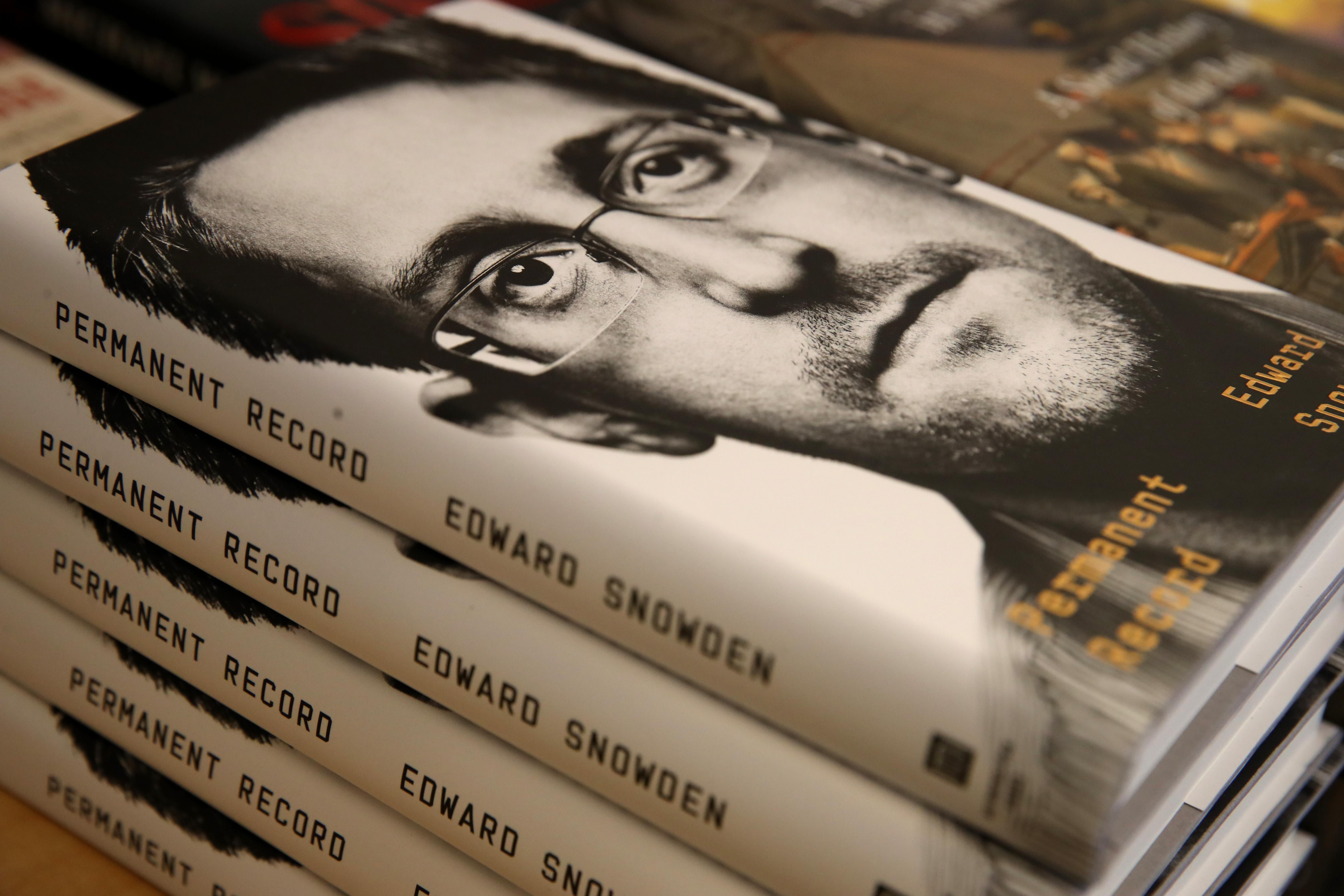 A stack of copies of the book Permanent Record by Edward Snowden. 