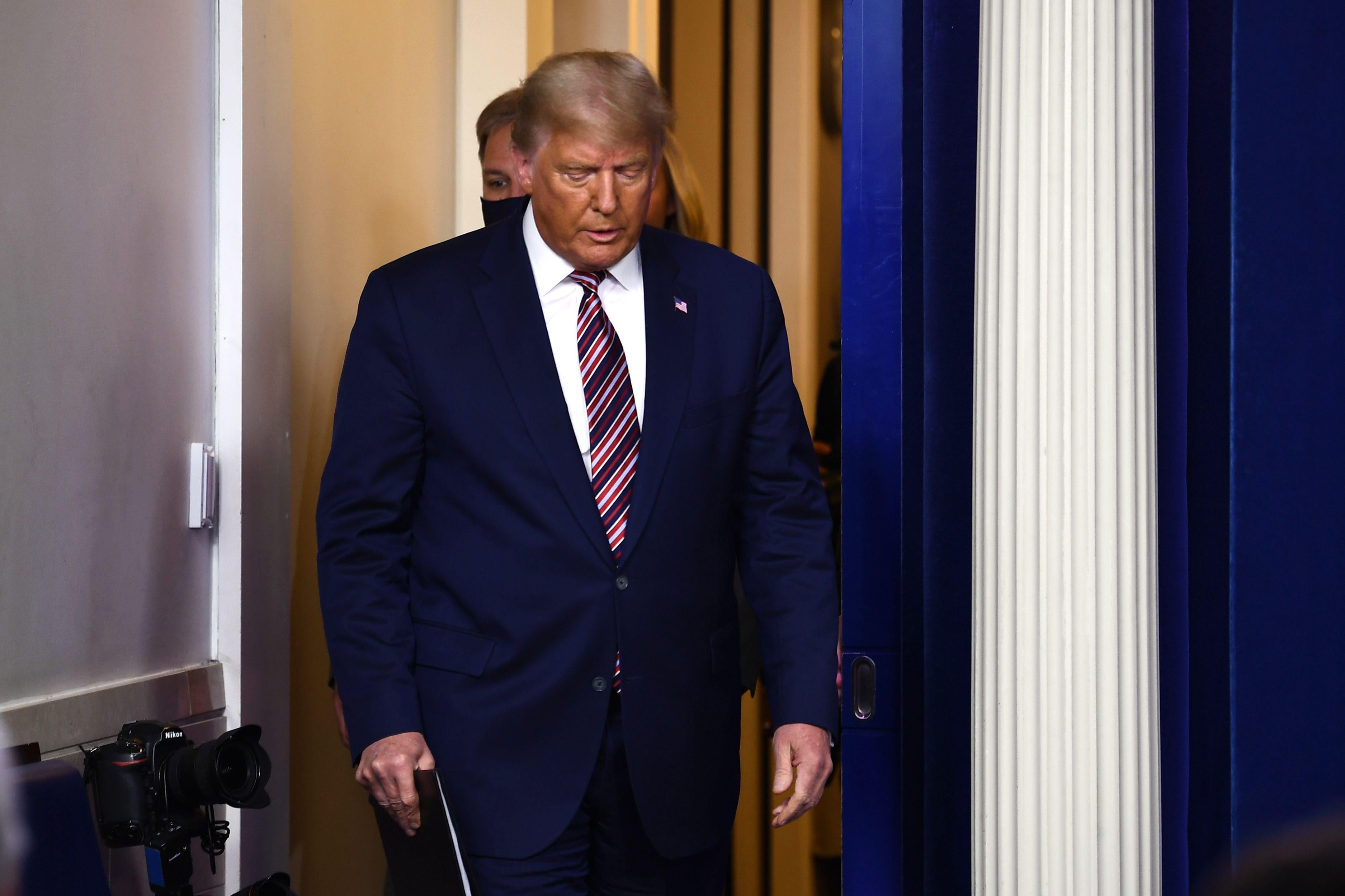 Donald Trump looks down as he walks.