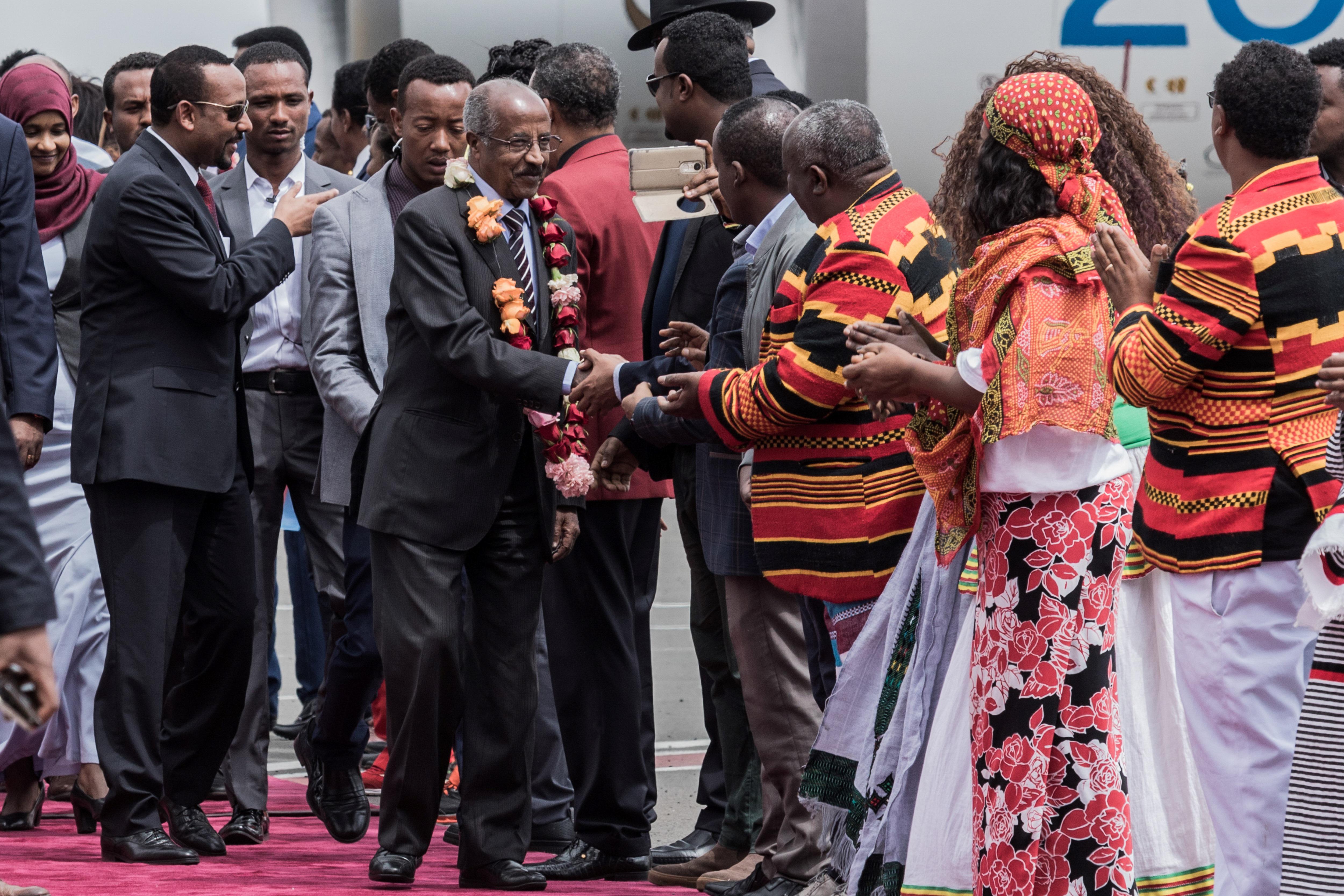Eritrean Foreign Minister Osman Saleh Mohammed walks with Ethiopian Prime Minister Abiy Ahmed as an Eritrean delegation for peace talks with Ethiopia arrives in Addis Ababa.