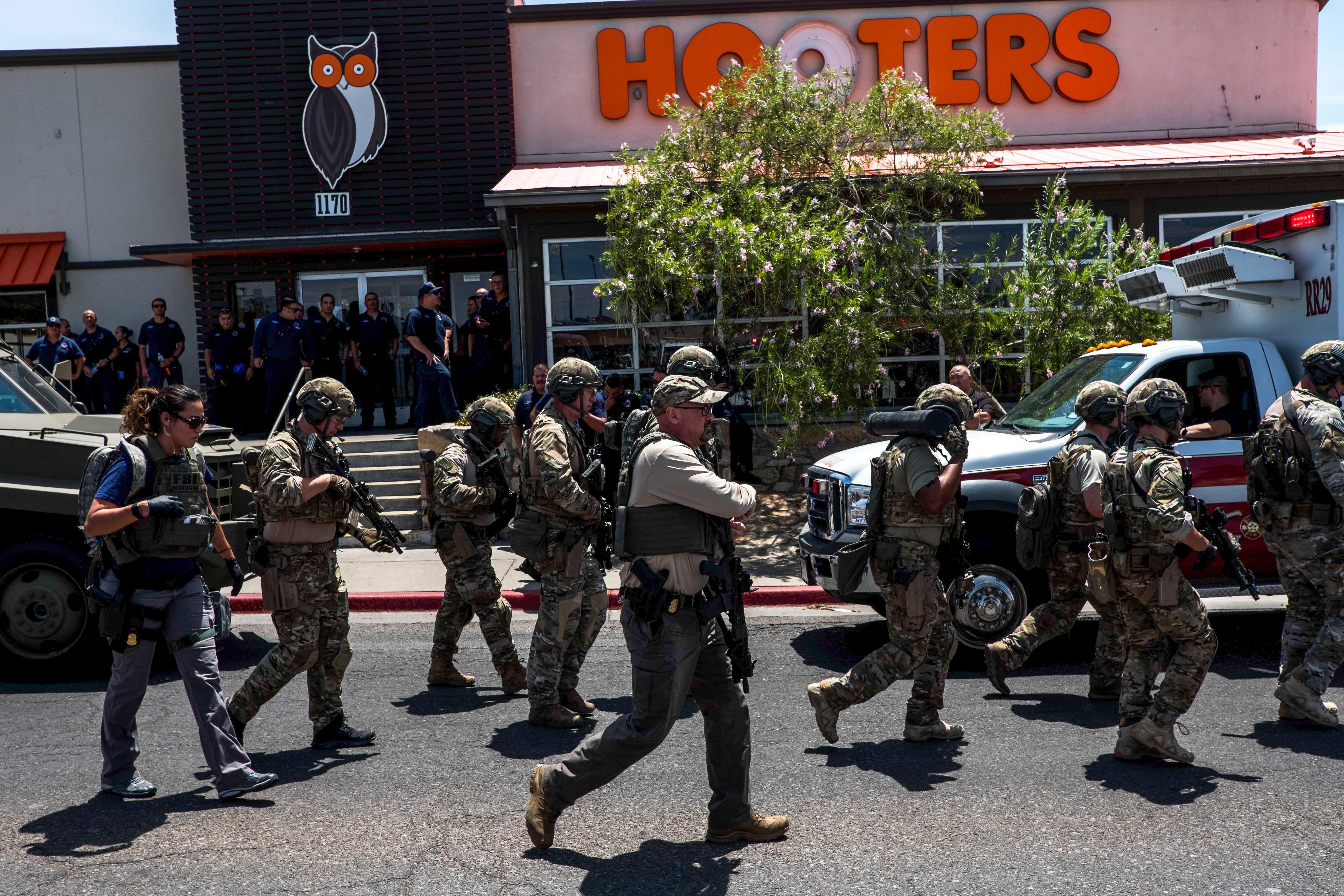 Uniformed officers on the street and outside a Hooters.