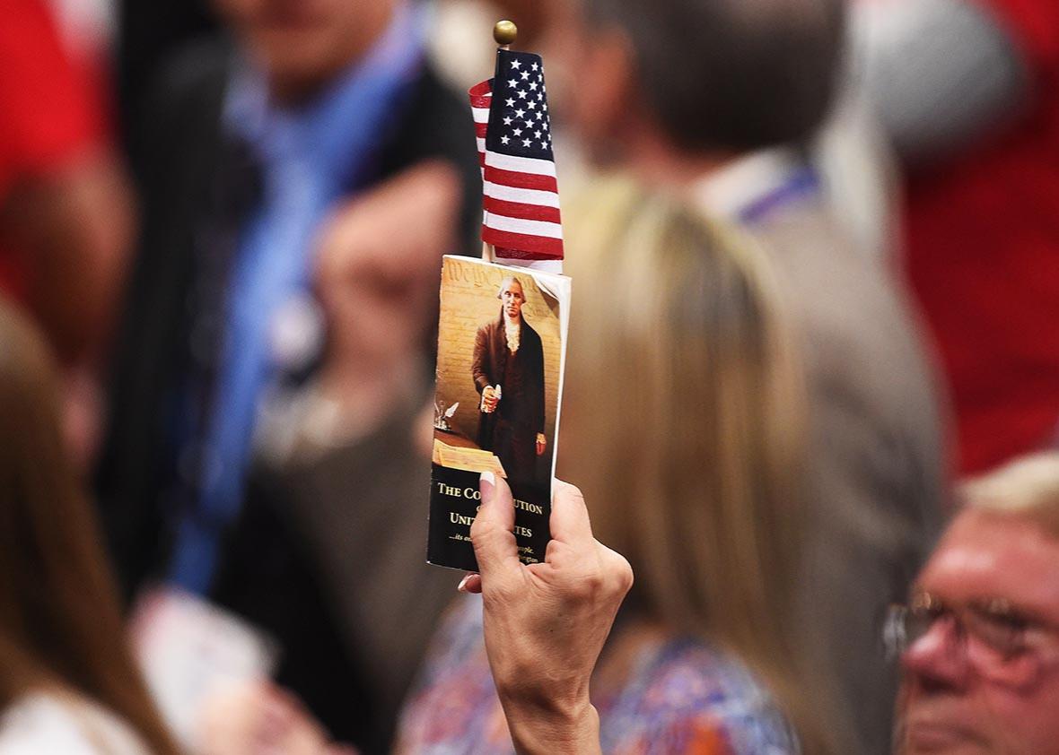A delegate holds up a copy of the constitution at the Republican National Convention at the Quicken Loans Arena in Cleveland, Ohio on July 20, 2016.