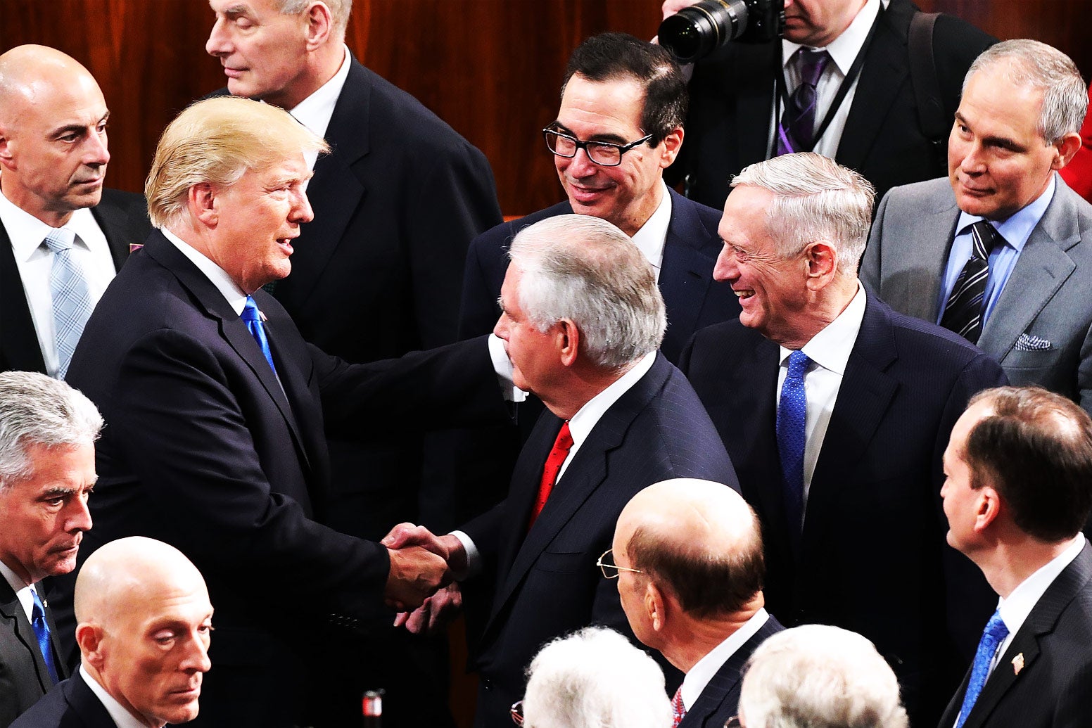 President Donald Trump talks with members of his Cabinet, including Treasury Secretary Steven Mnuchin, Secretary of State Rex Tillerson, Defense Secretary James Mattis, and EPA Administrator Scott Pruitt, following the State of the Union address in the chamber of the House of Representatives on Jan. 30 in Washington.