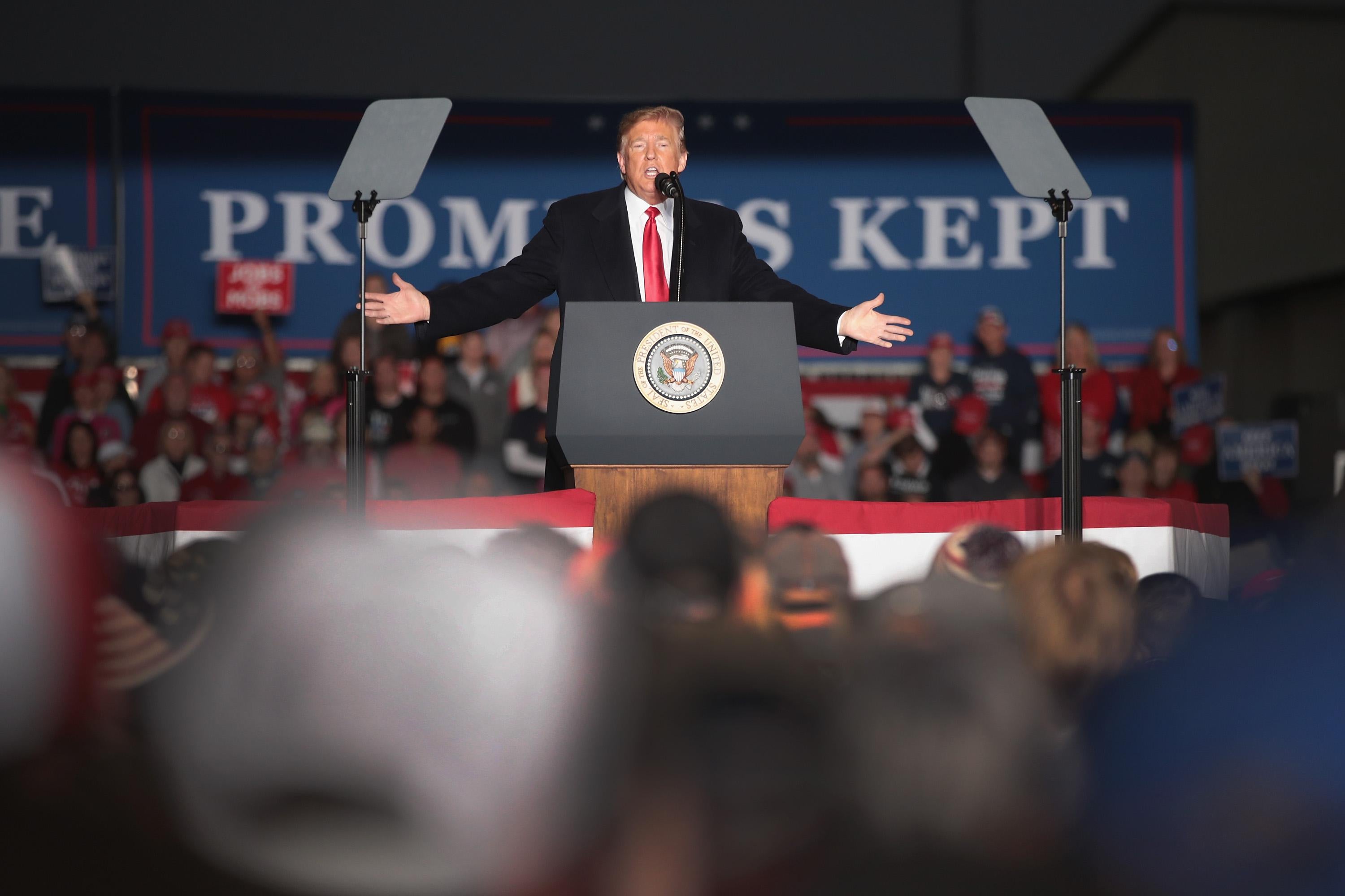 President Donald Trump at podium at a rally.