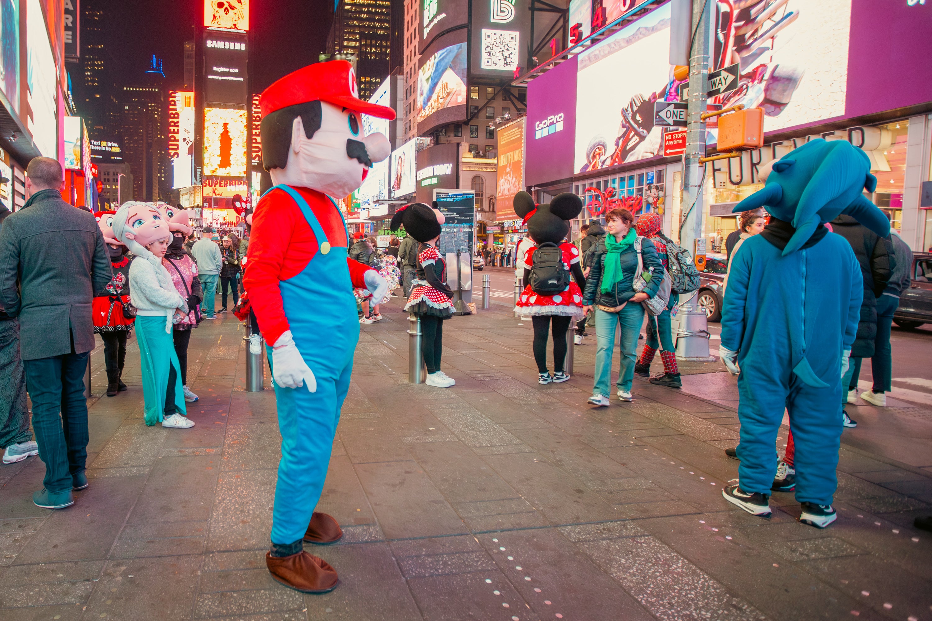 Luke, in the Mario costume, in Times Square and glancing at passersby.