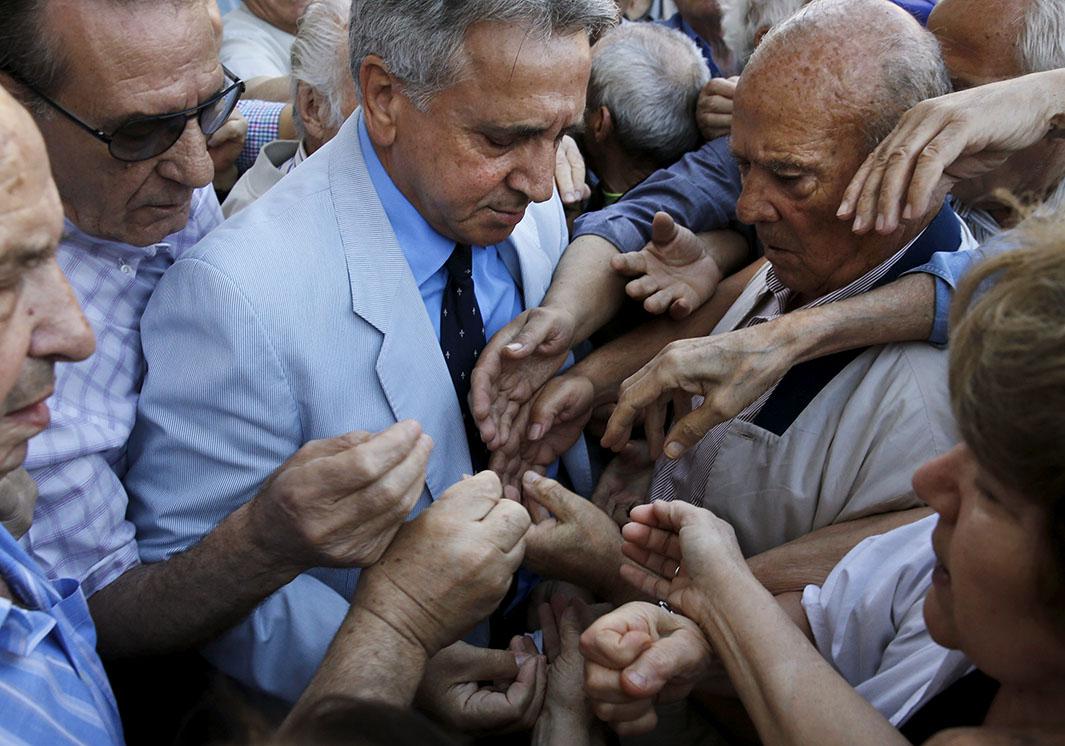 Pensioners are given priority tickets by a National Bank branch 