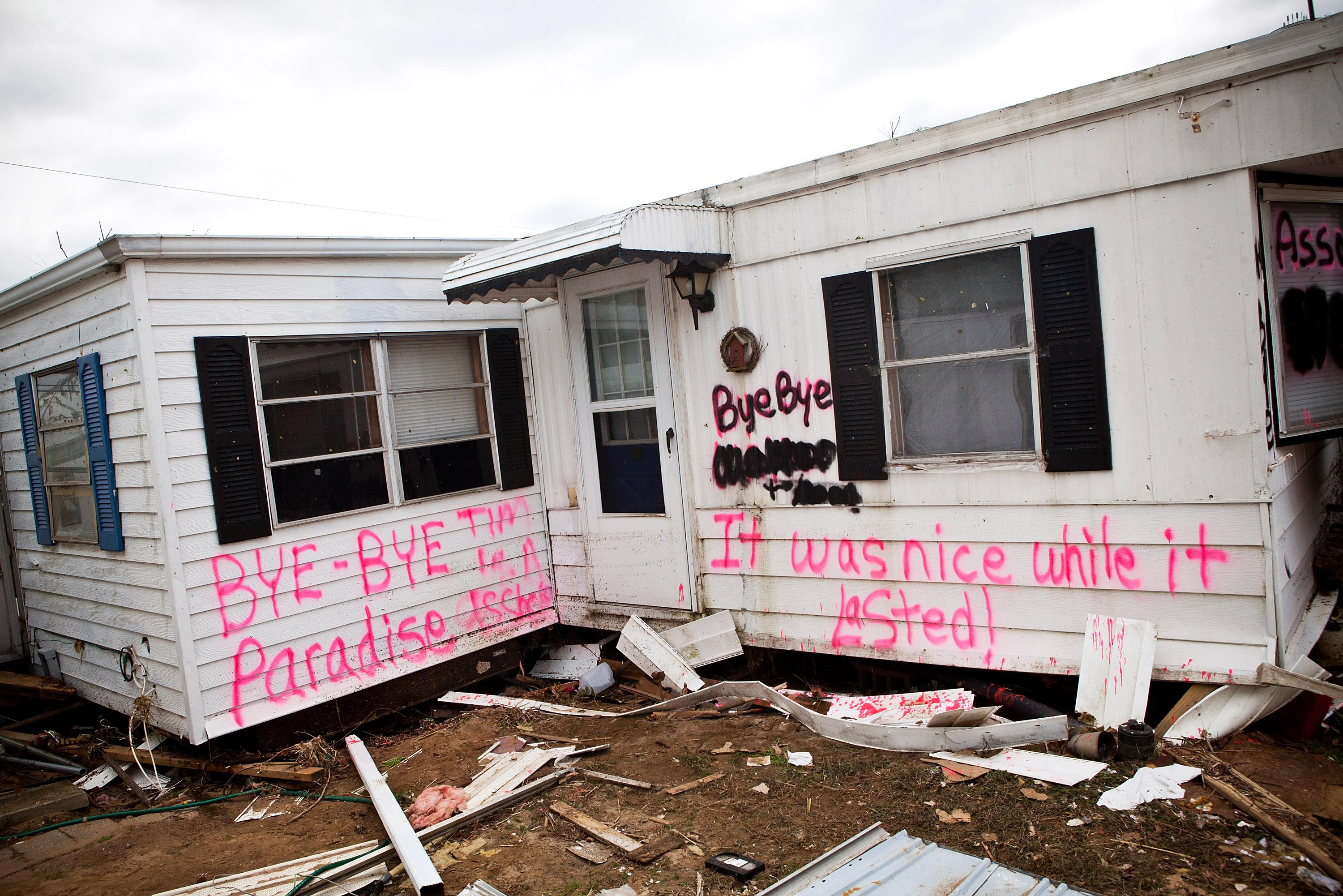 An abandoned trailer home, with the words, 'Bye-bye Paradise, it was nice while it lasted,' spray painted on its side, is seen in the Paradise Park trailer Park on November 1, 2012