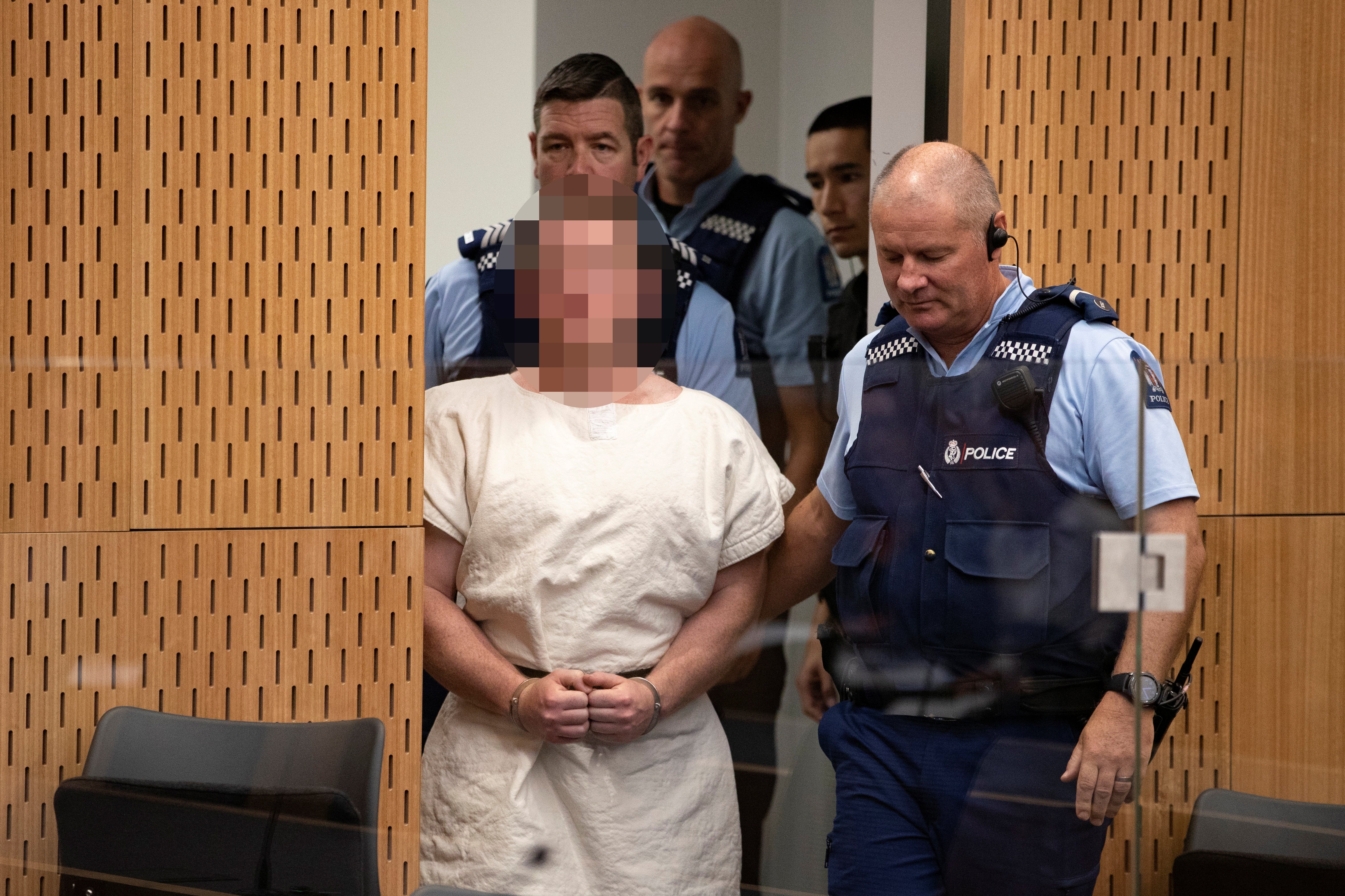 Brenton Tarrant, charged for murder in relation to the mosque attacks, is lead into the dock for his appearance in the Christchurch District Court, New Zealand March 16, 2019. 