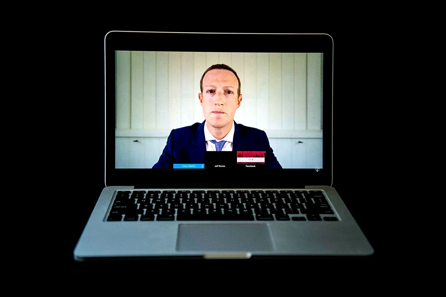 Mark Zuckerberg in a suit as seen on a laptop.