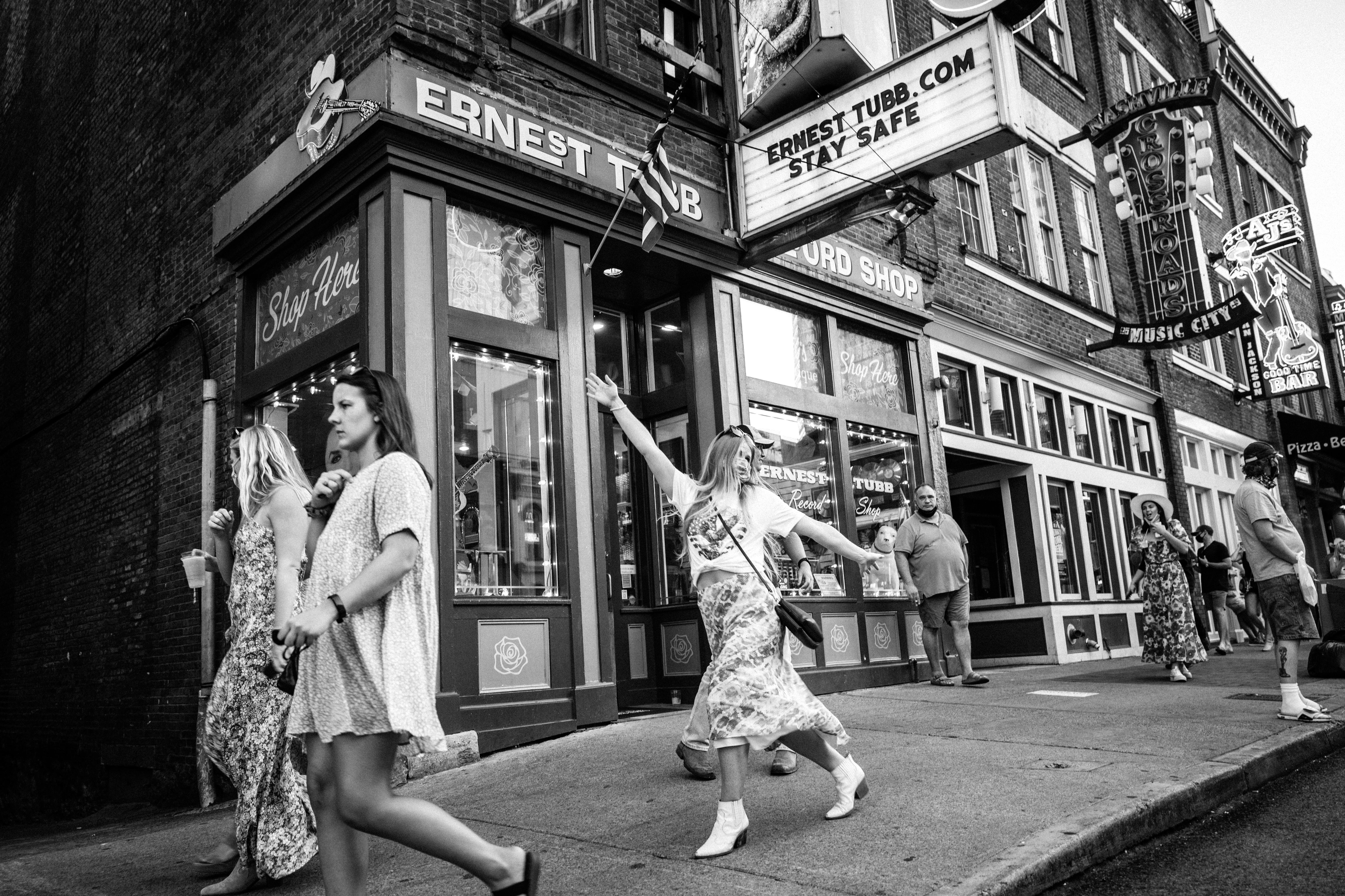A black-and-white photo of women partying on Broadway in Nashville.