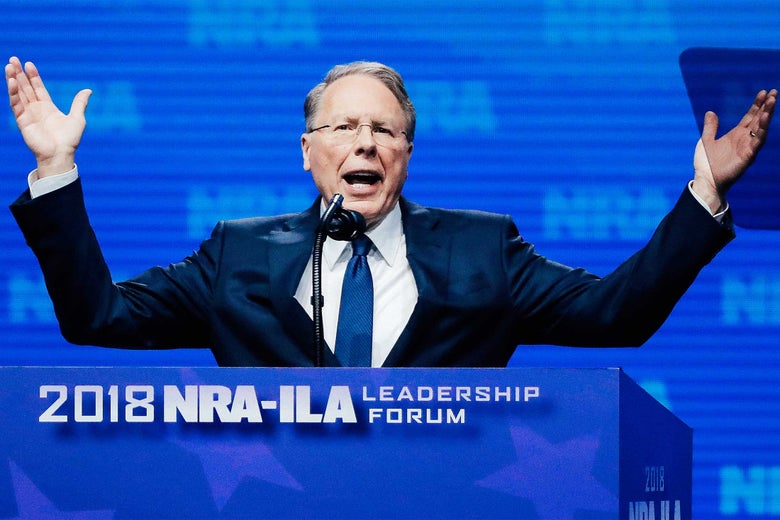 Wayne LaPierre gestures from behind a podium.